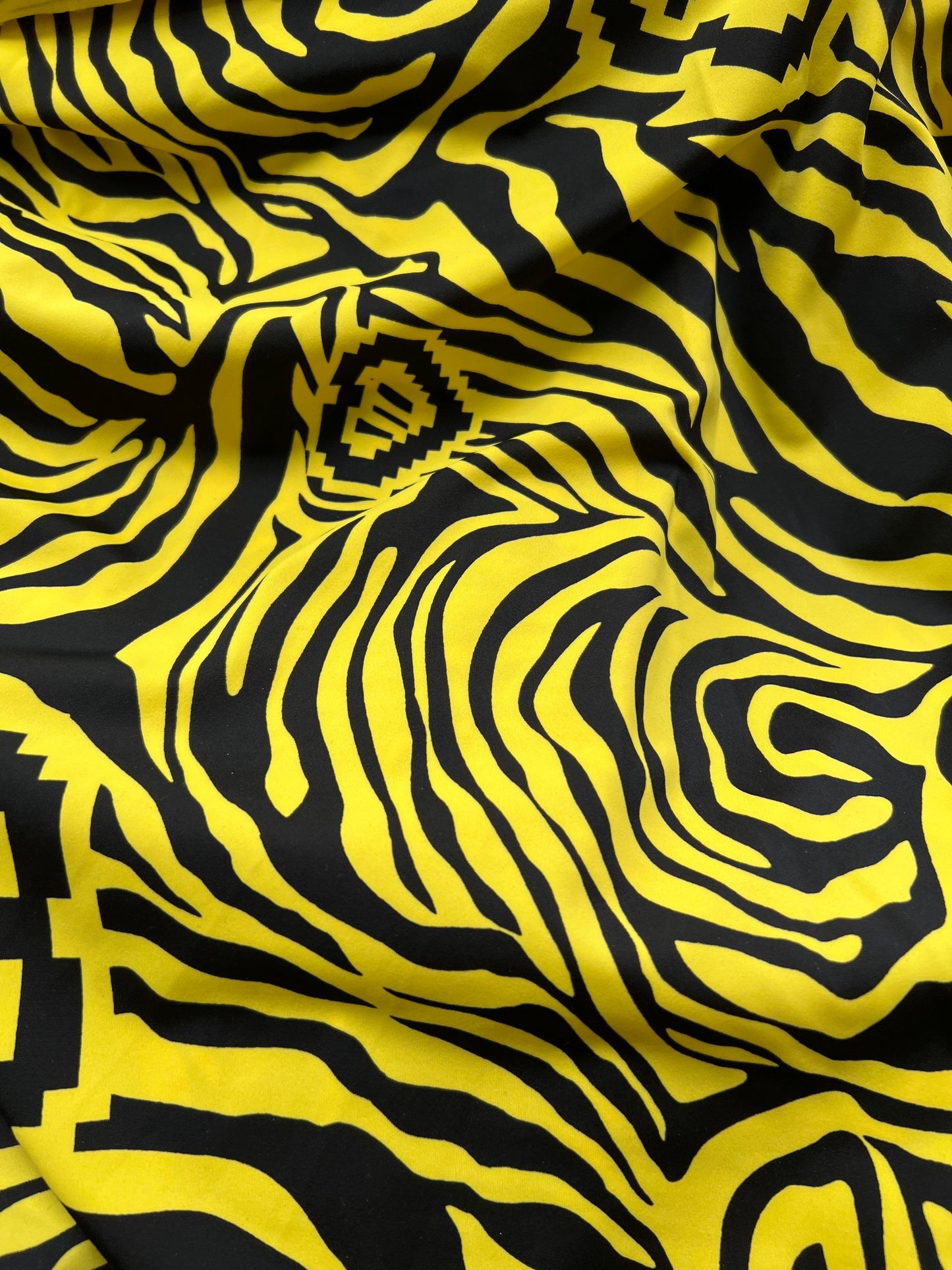 Exotic zebra design black/yellow print on nylon spandex 4way stretch 58/60” Sold by the YD. Ships worldwide from Los Angeles California USA.