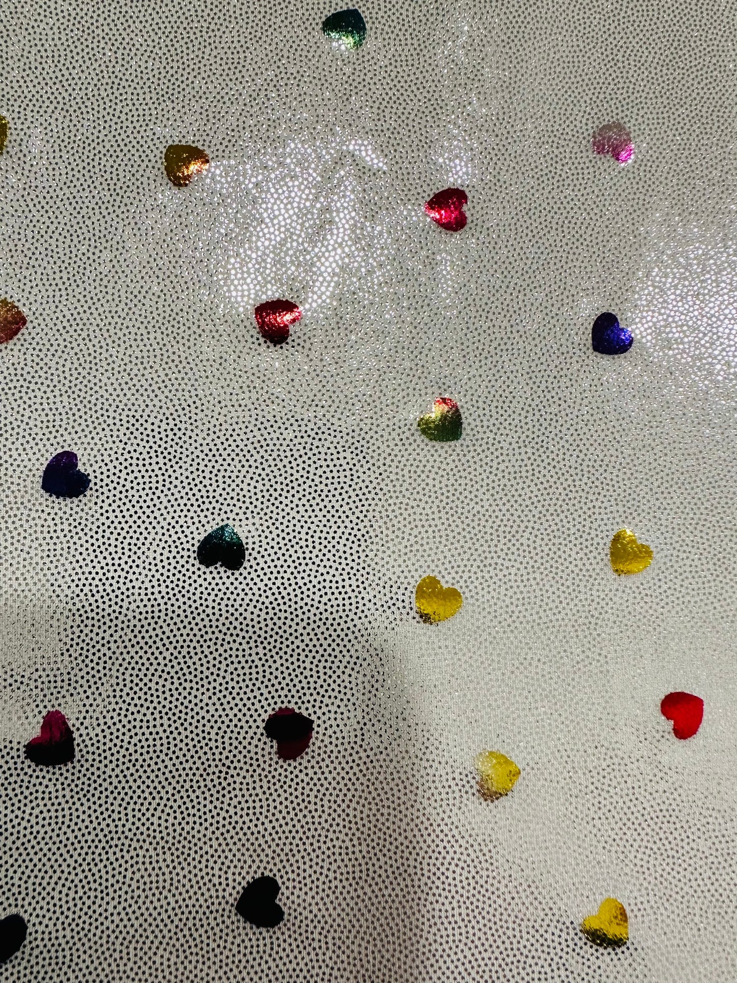 Hearts design metallic hologram nylon spandex W/Silver multicolor 4-way stretch spandex 58/60” Sold by the YD. Ships worldwide from L.A