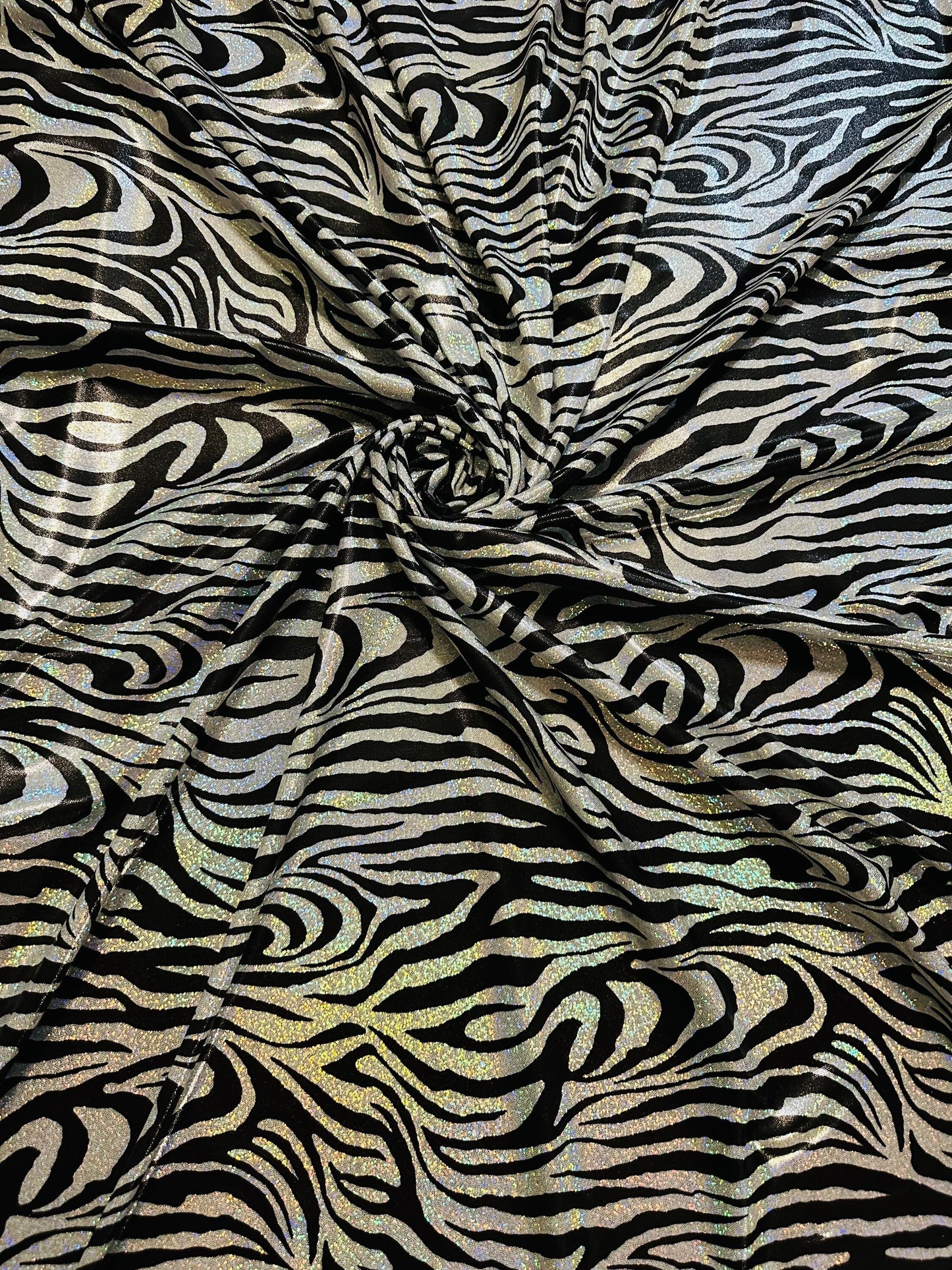 Wild Zebra design hologram metallic nylon spandex with iridescent foggy foil 58/60” 4-way stretch.