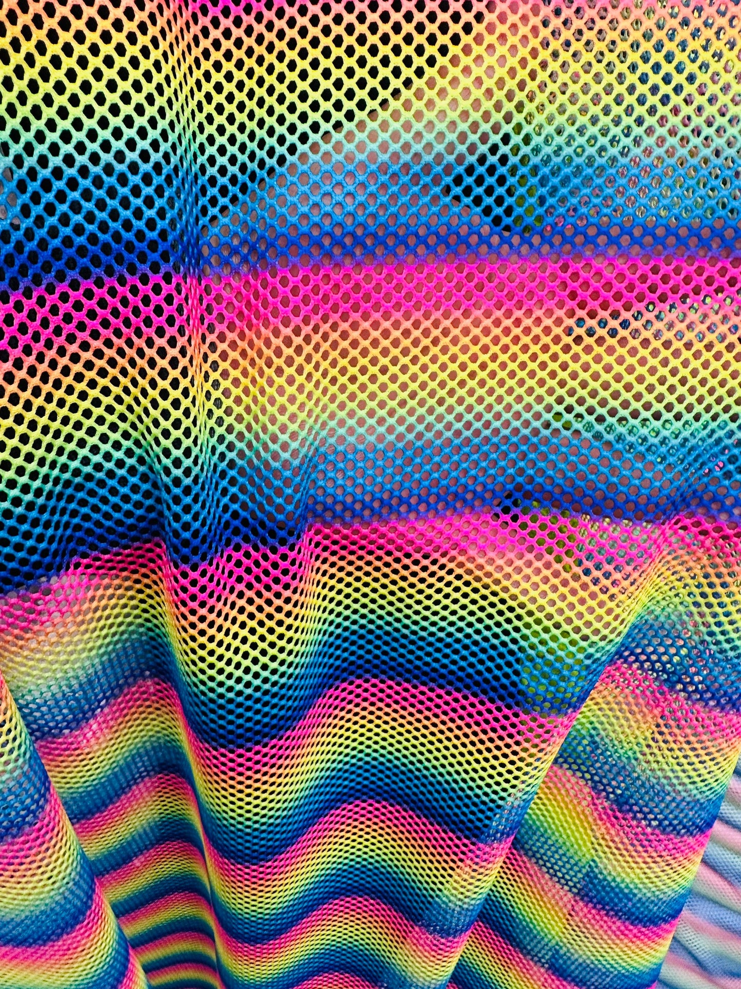 New Rainbow design print on fishnet 2-way stretch 58/60” Sold by the YD.
