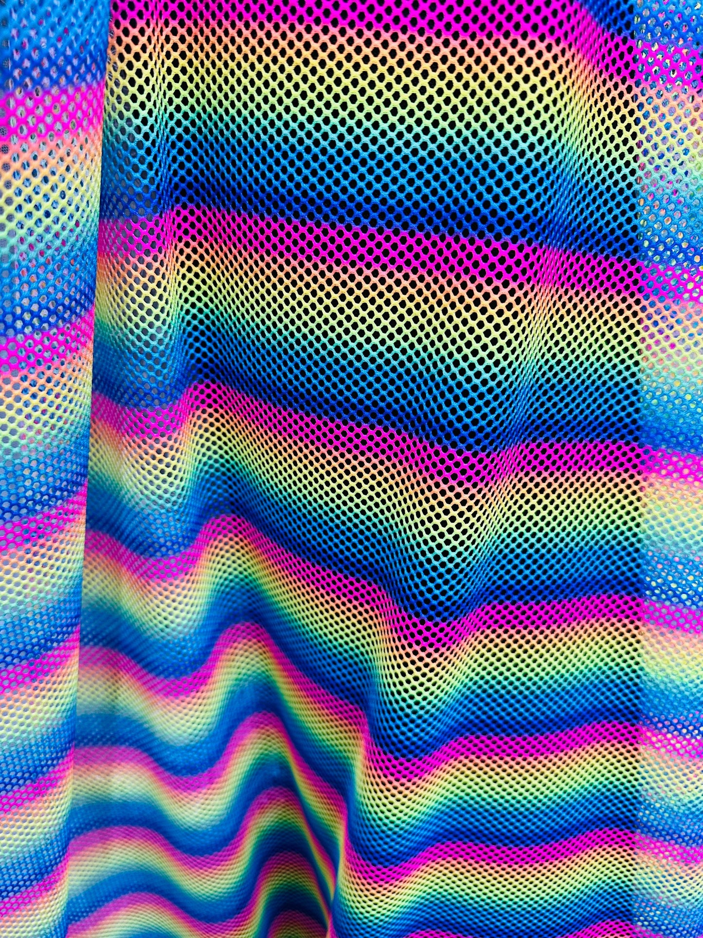New Rainbow design print on fishnet 2-way stretch 58/60” Sold by the YD.