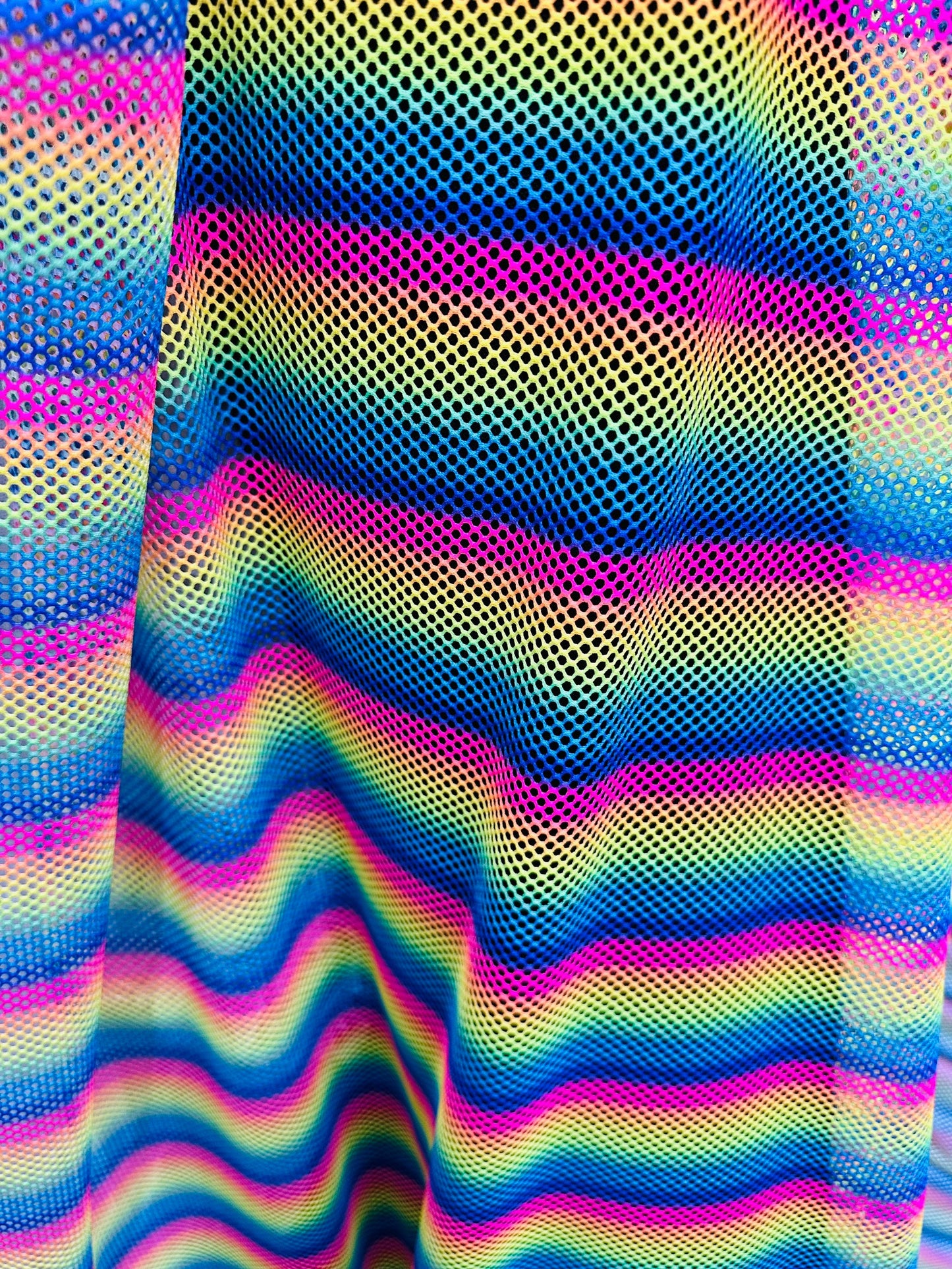 New Rainbow design print on fishnet 2-way stretch 58/60” Sold by the YD.