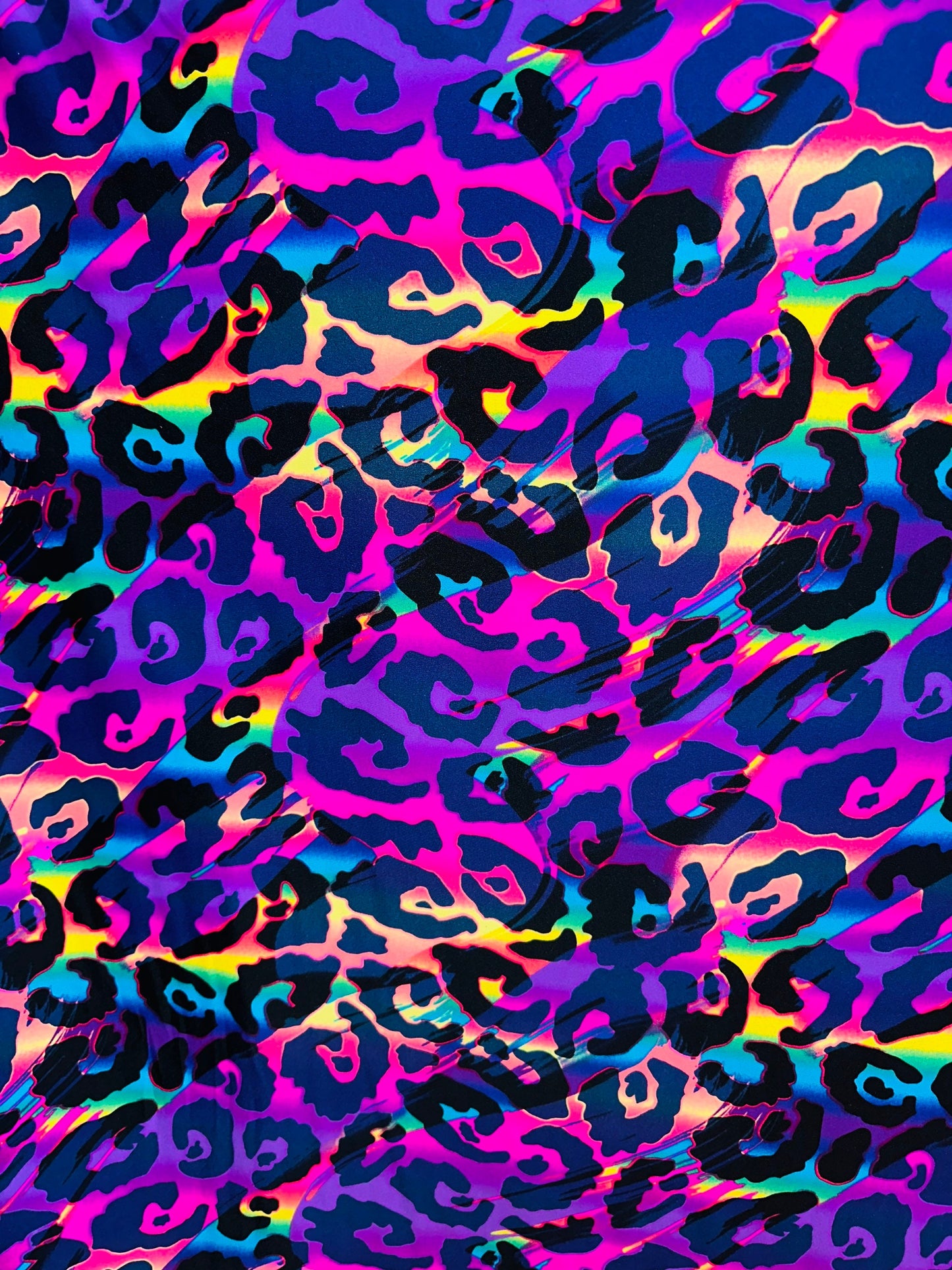 Wildcat design multicolor print on best quality of nylon spandex 4-way stretch UV light it glows under black light 58/60” Sold by the YD.