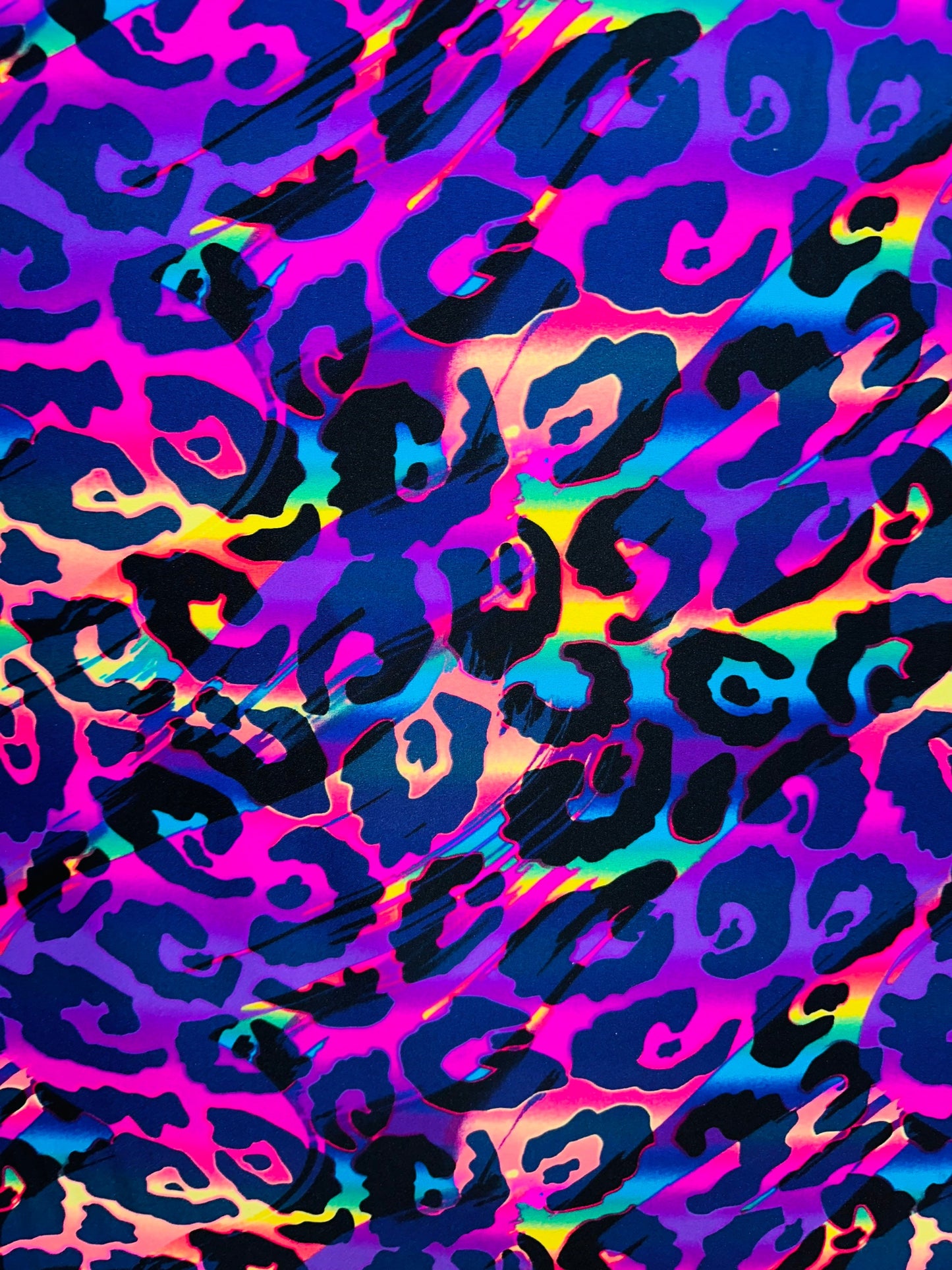 Wildcat design multicolor print on best quality of nylon spandex 4-way stretch UV light it glows under black light 58/60” Sold by the YD.
