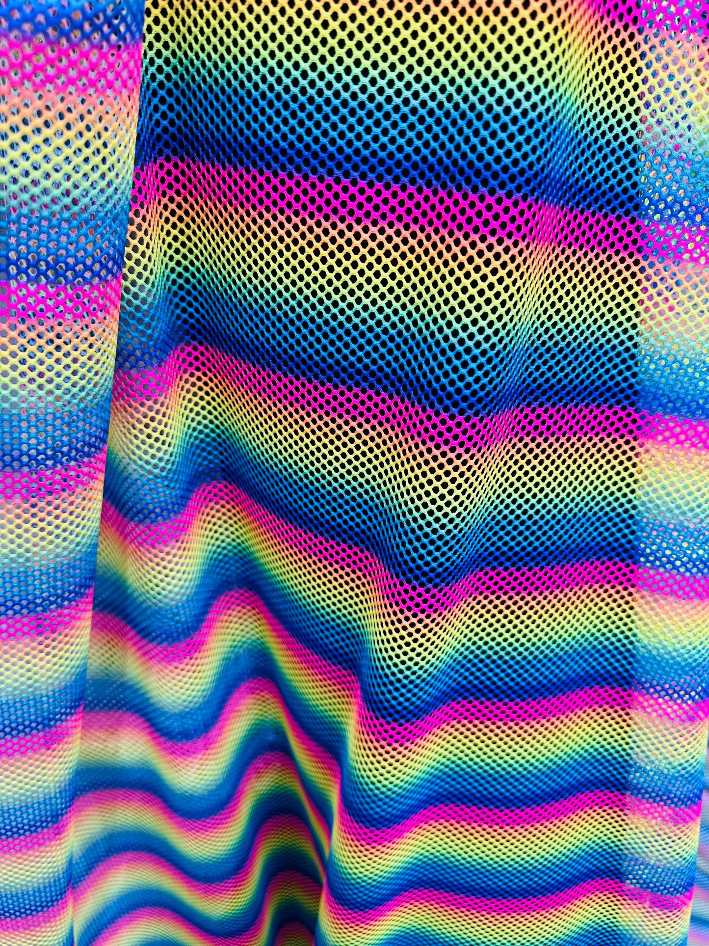 New Rainbow design print on fishnet 2-way stretch 58/60” Sold by the YD.