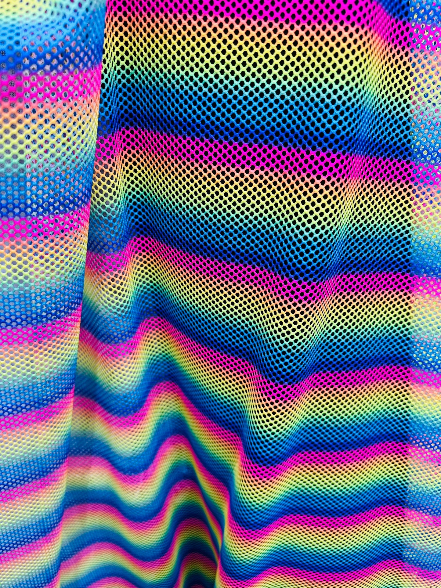 New Rainbow design print on fishnet 2-way stretch 58/60” Sold by the YD.