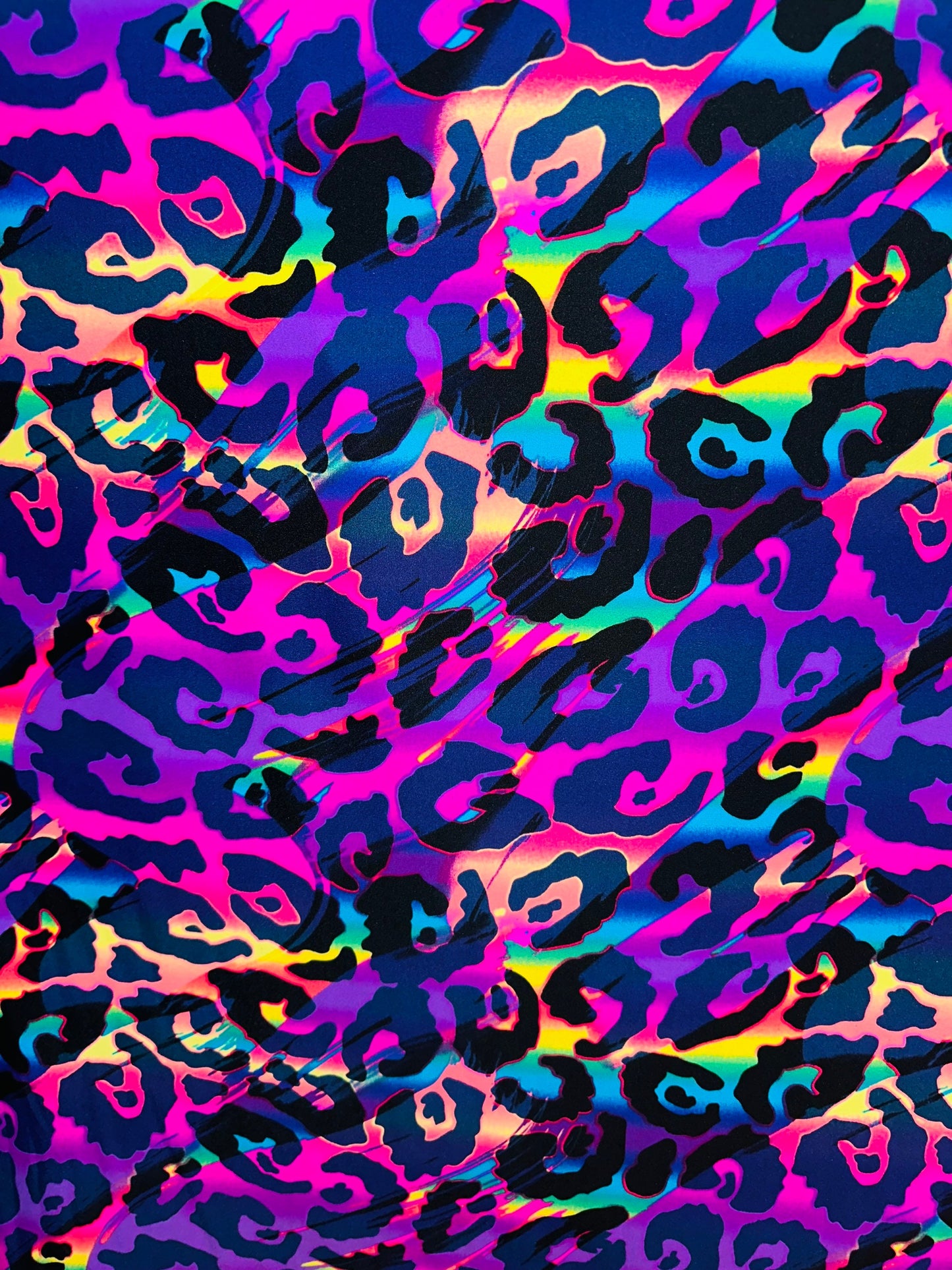 Wildcat design multicolor print on best quality of nylon spandex 4-way stretch UV light it glows under black light 58/60” Sold by the YD.