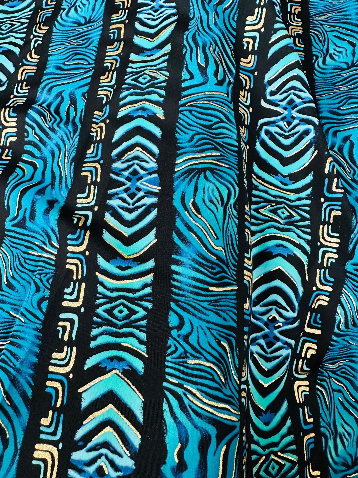 Exotic zebra design on best quality of nylon spandex with gold foil 4-way stretch 58/60” Sold by the YD.
