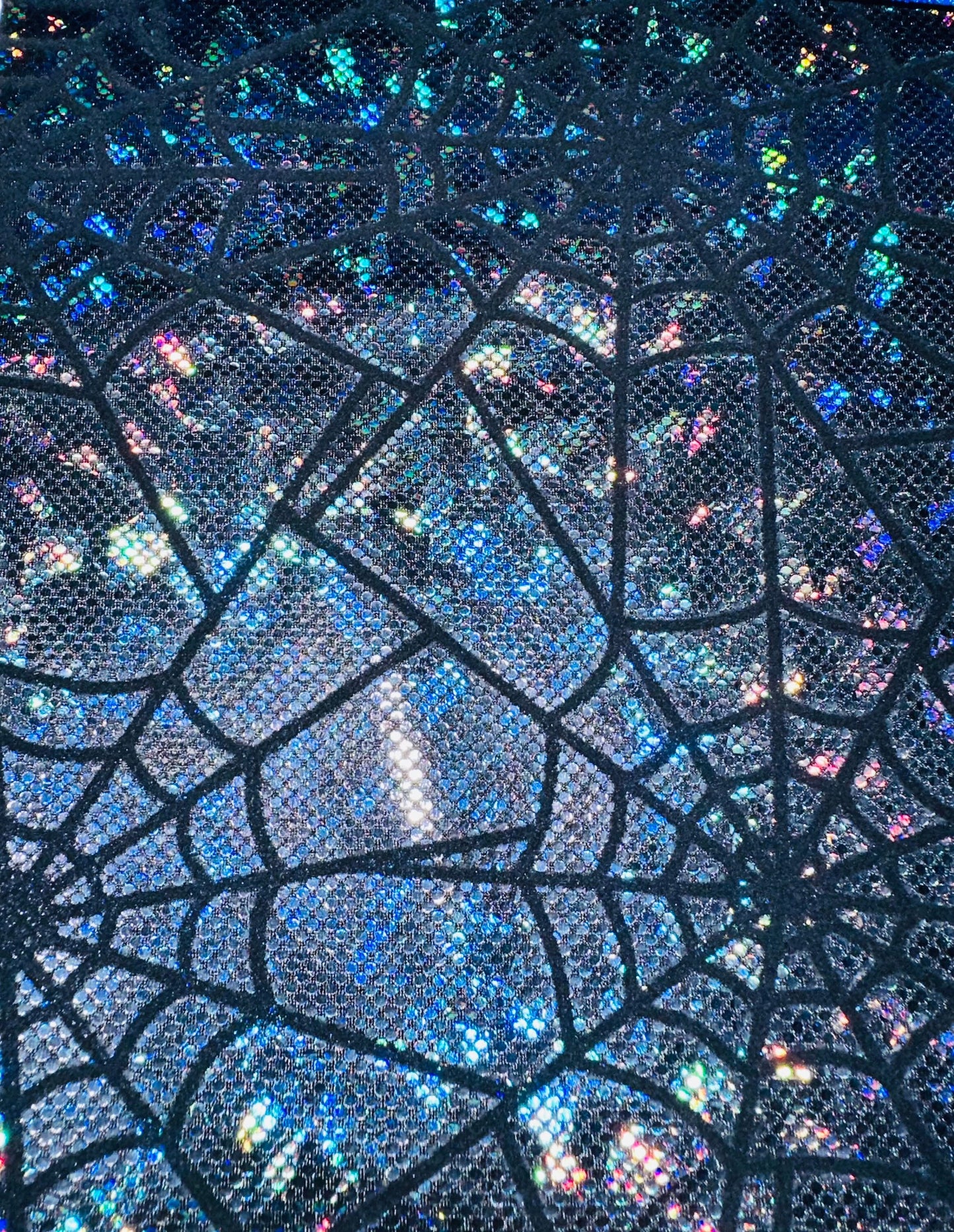 Amazing Spiderweb design on metallic hologram shattered glass nylon spandex with flocking 4-way stretch 58/60” Sold by the YD.