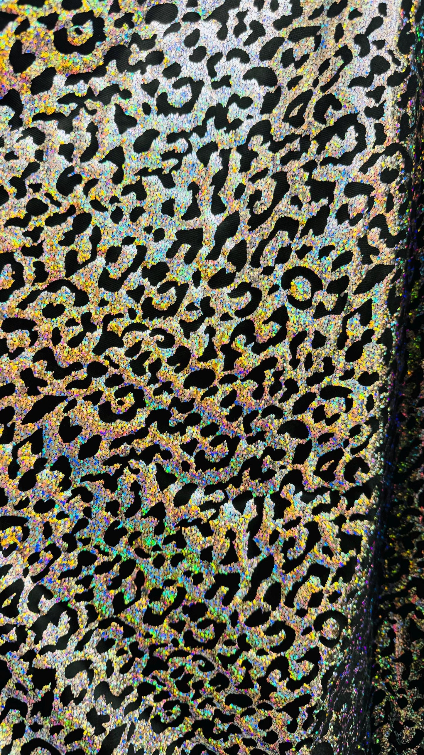Hologram exotic leopard design metallic poly spandex 2-way stretch 58/60” Sold by the YD. Ships worldwide from Los Angeles California USA.