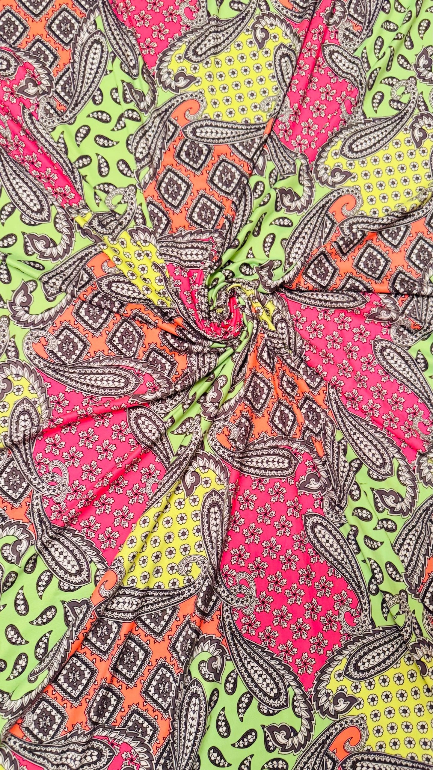New paisley design Neon colors multicolor print on poly spandex jersey 4-way stretch 58/60” Sold by the YD. High quality fabrics