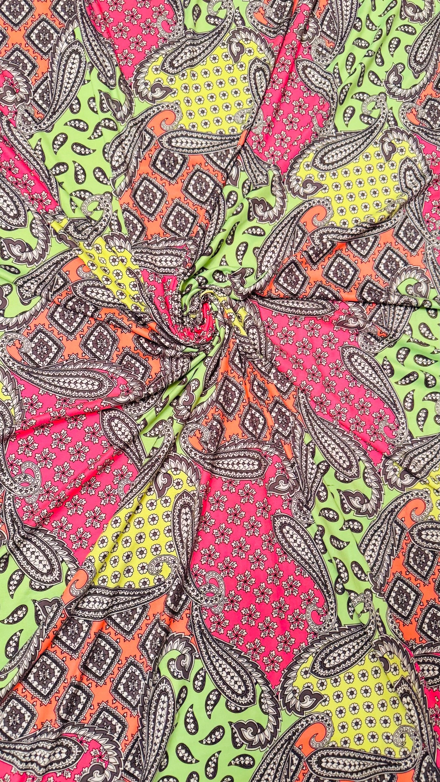 New paisley design Neon colors multicolor print on poly spandex jersey 4-way stretch 58/60” Sold by the YD. High quality fabrics