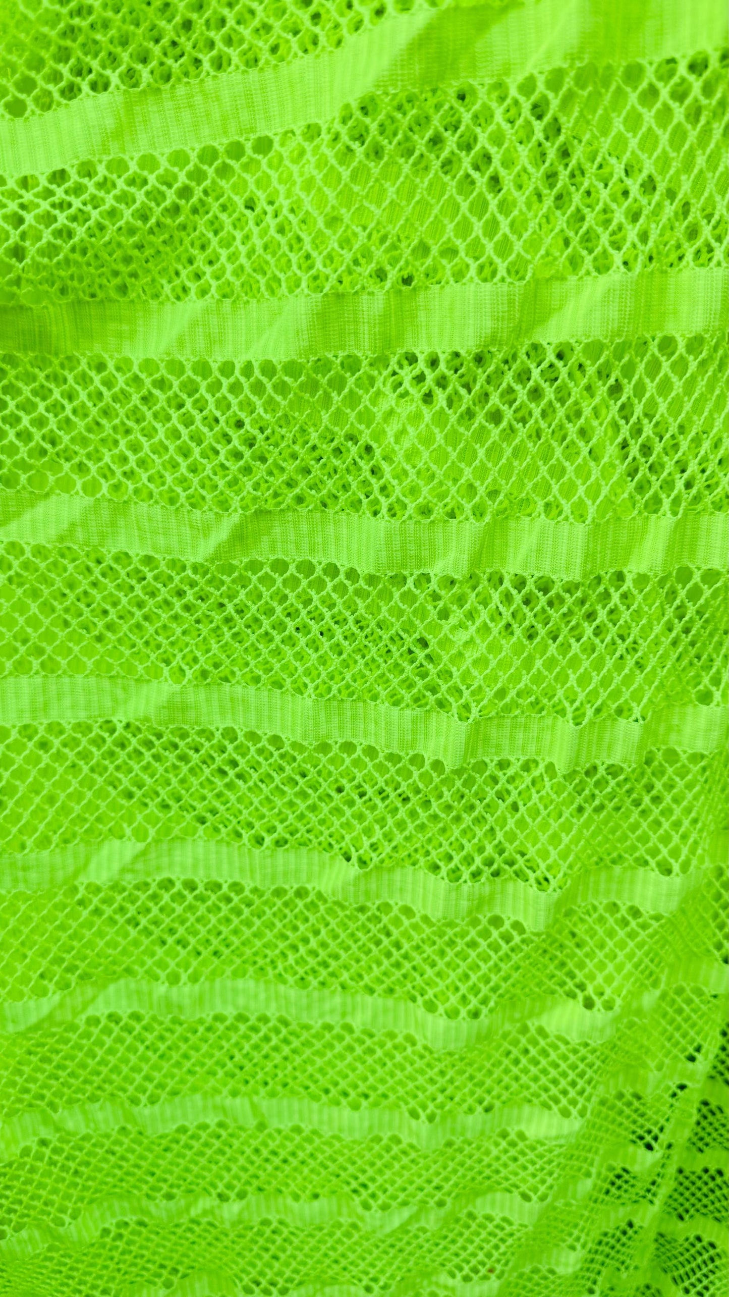 New fishnet Neon Green with stripe design nylon spandex 2way stretch 58/60” Sold by the YD. Ships worldwide from Los Angeles California USA