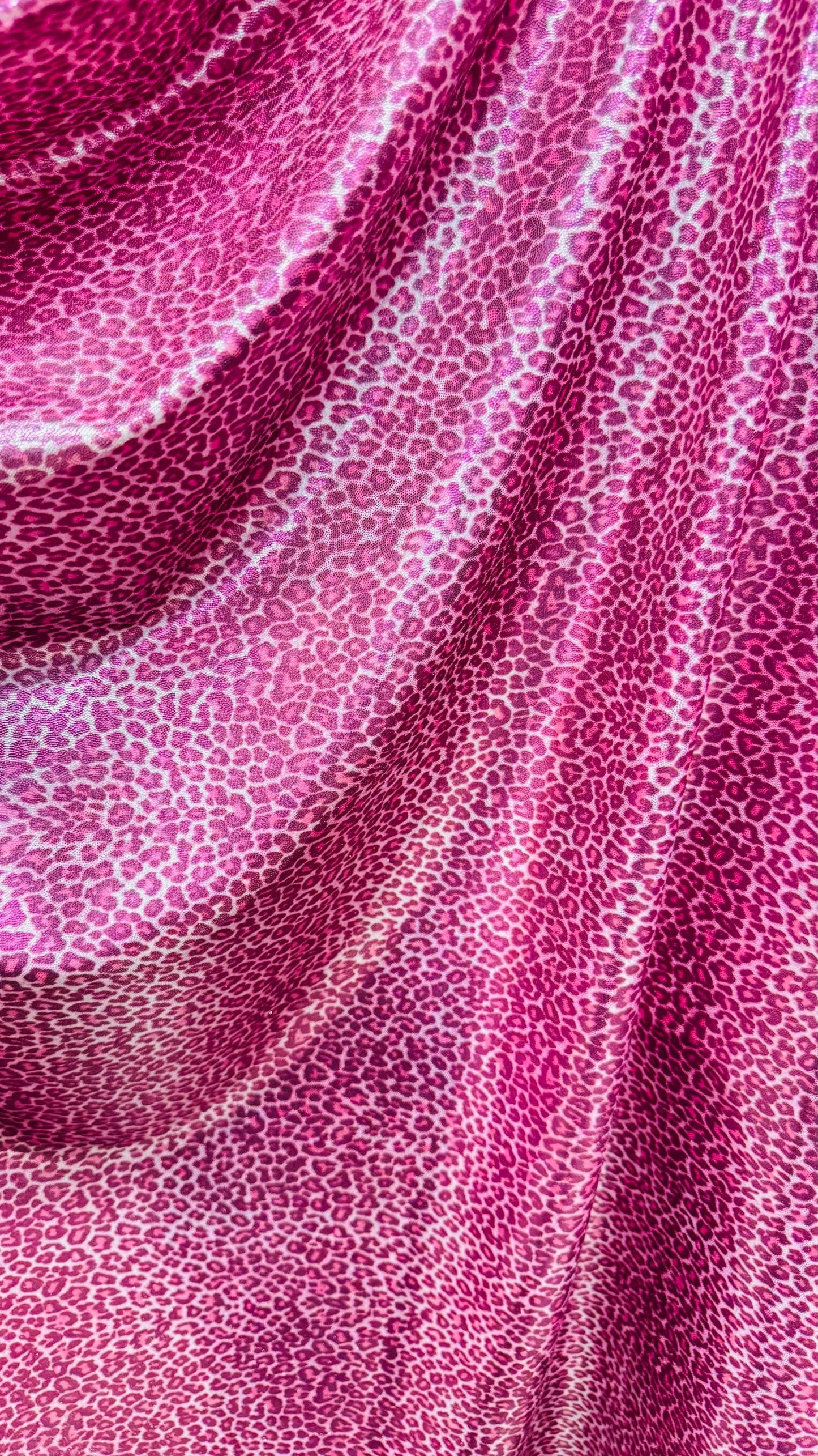 Wild Cheetah pink design Small size on foggy foil metallic nylon spandex 4-way stretch 58/60” Sold by the YD. Ships worldwide