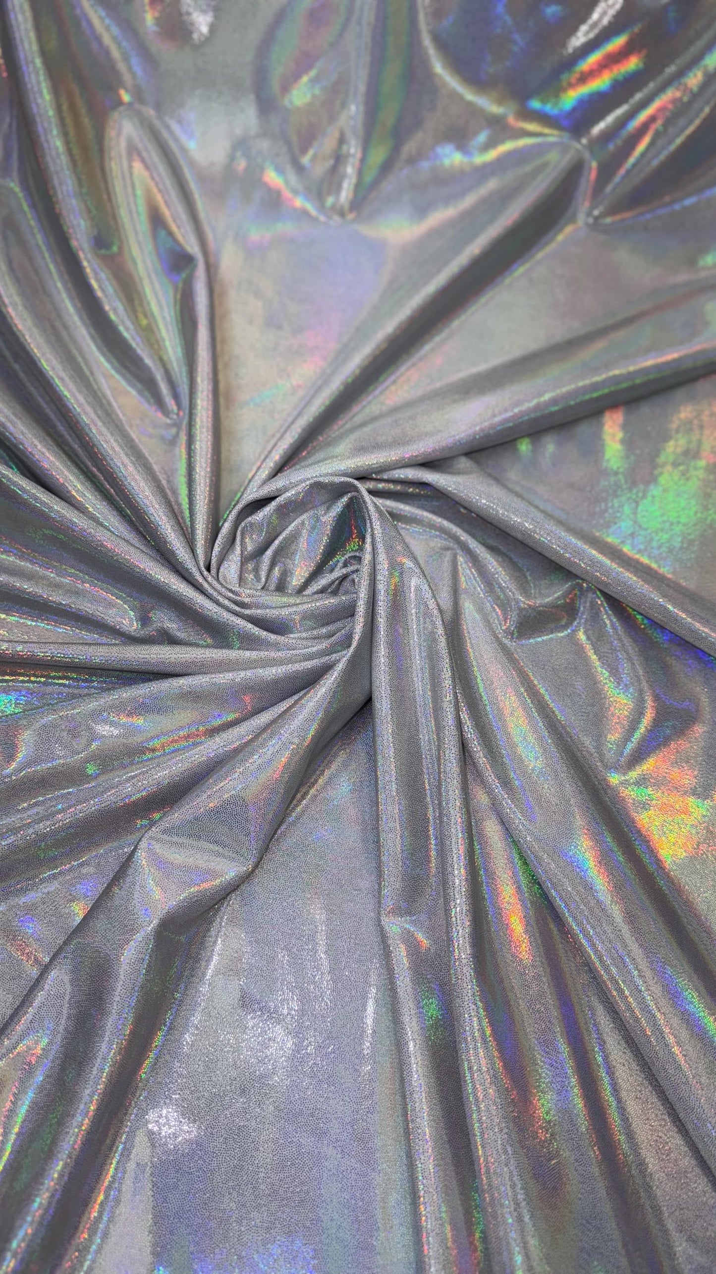 New oil slick iridescent white/silver hologram metallic nylon spandex 4-way stretch 58/60” Sold by the YD. Ships worldwide from L.A