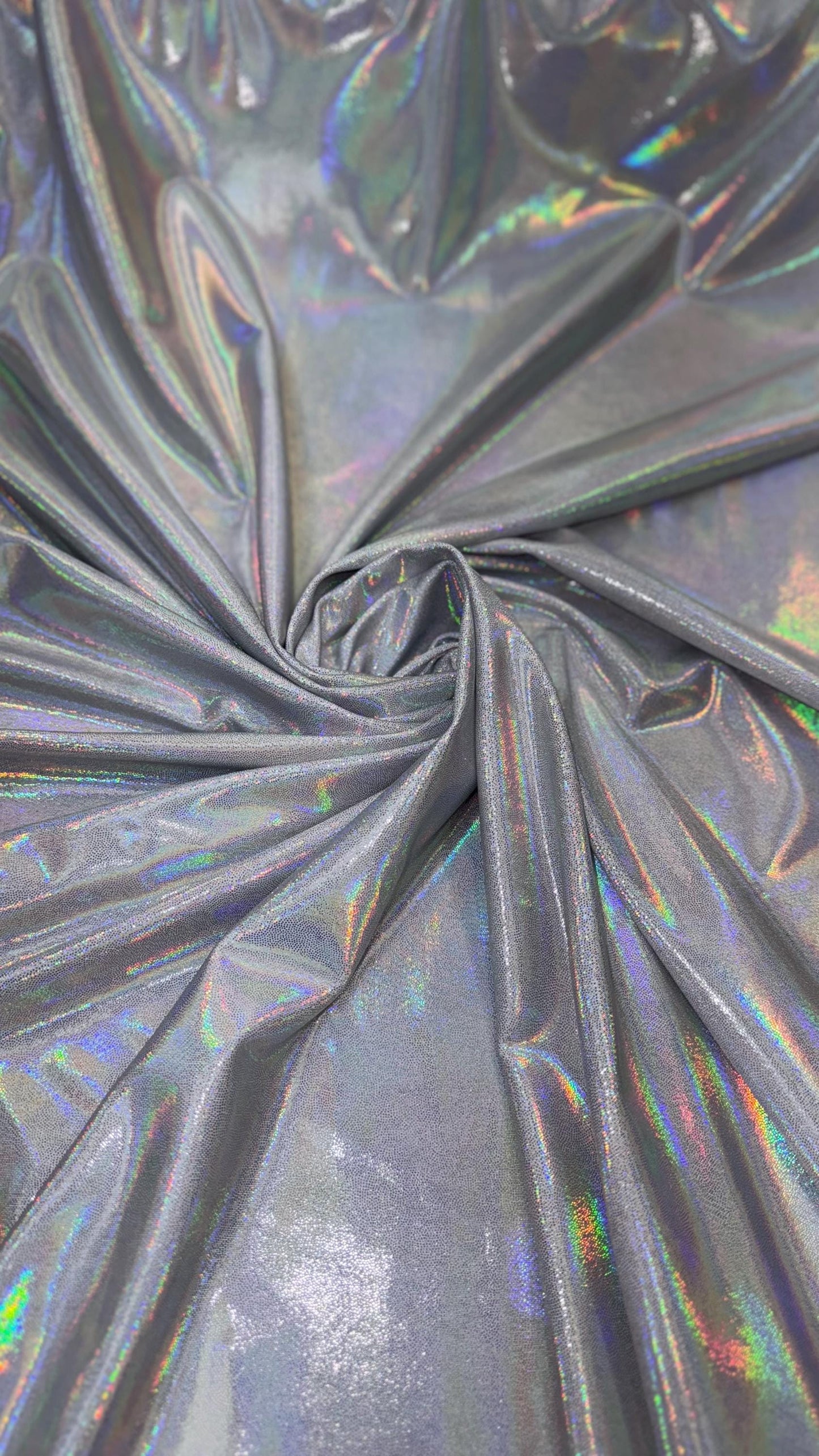 New oil slick iridescent white/silver hologram metallic nylon spandex 4-way stretch 58/60” Sold by the YD. Ships worldwide from L.A