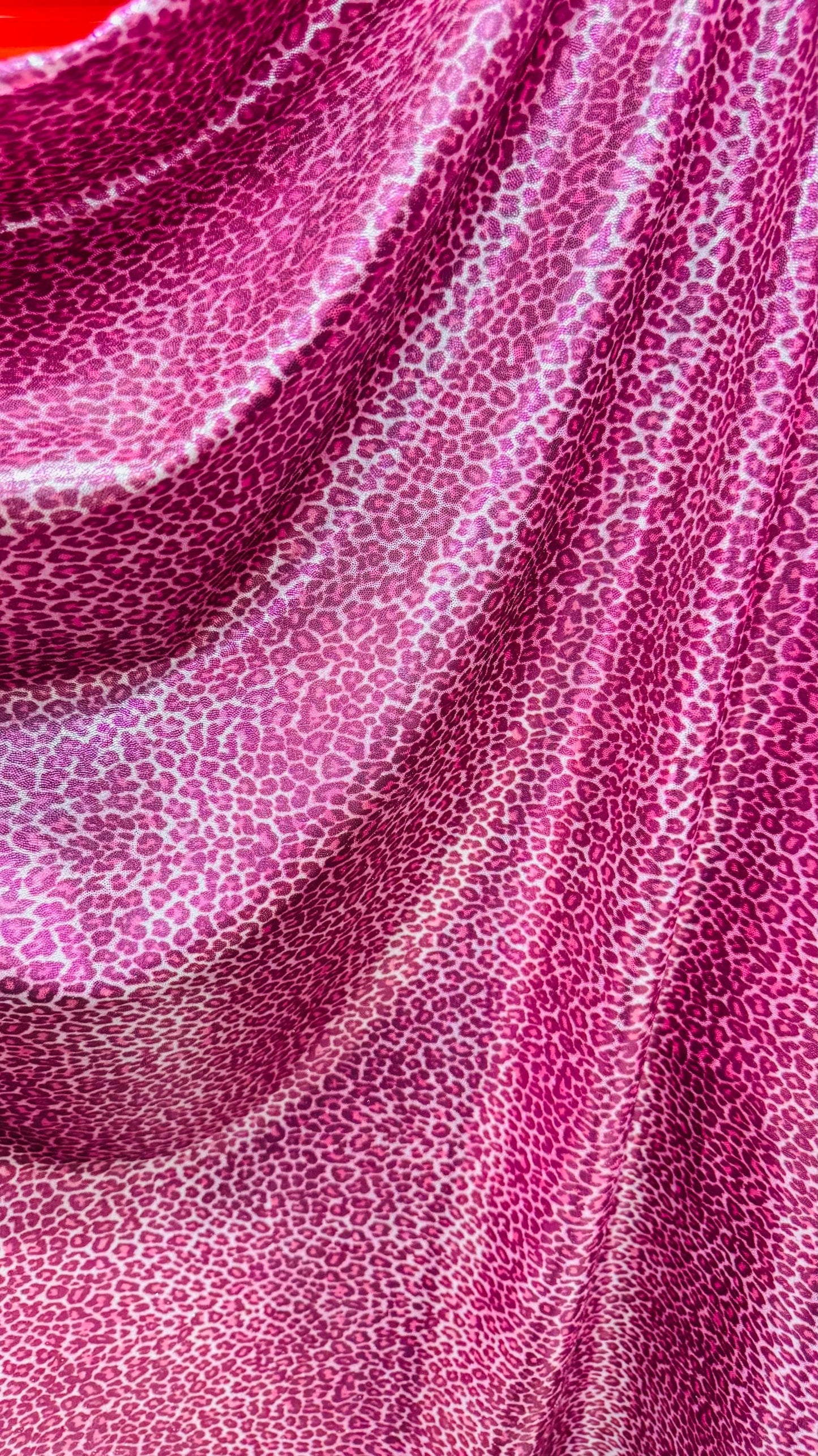 Wild Cheetah pink design Small size on foggy foil metallic nylon spandex 4-way stretch 58/60” Sold by the YD. Ships worldwide