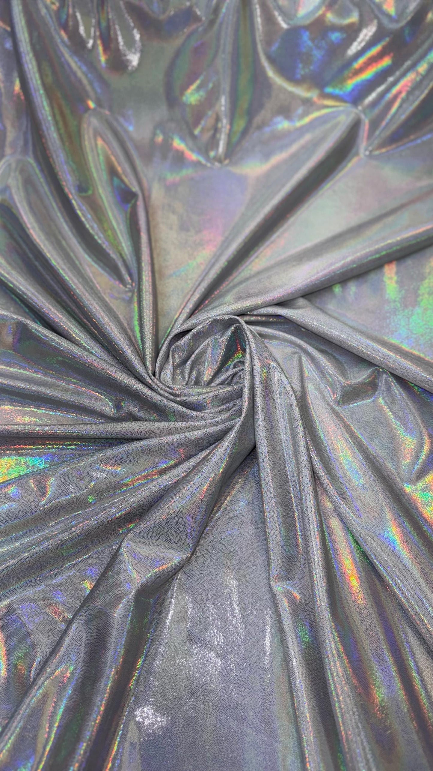 New oil slick iridescent white/silver hologram metallic nylon spandex 4-way stretch 58/60” Sold by the YD. Ships worldwide from L.A