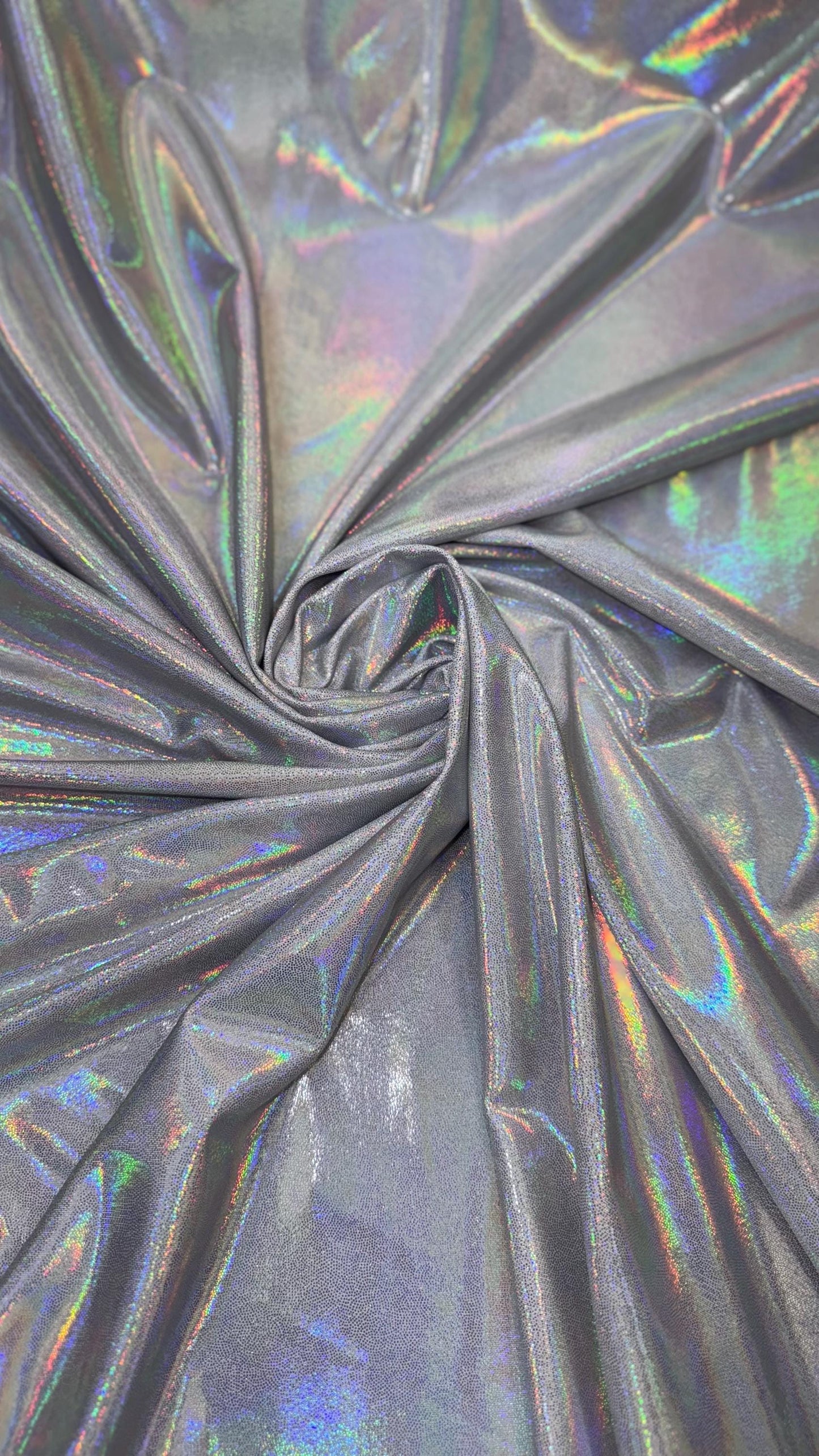 New oil slick iridescent white/silver hologram metallic nylon spandex 4-way stretch 58/60” Sold by the YD. Ships worldwide from L.A