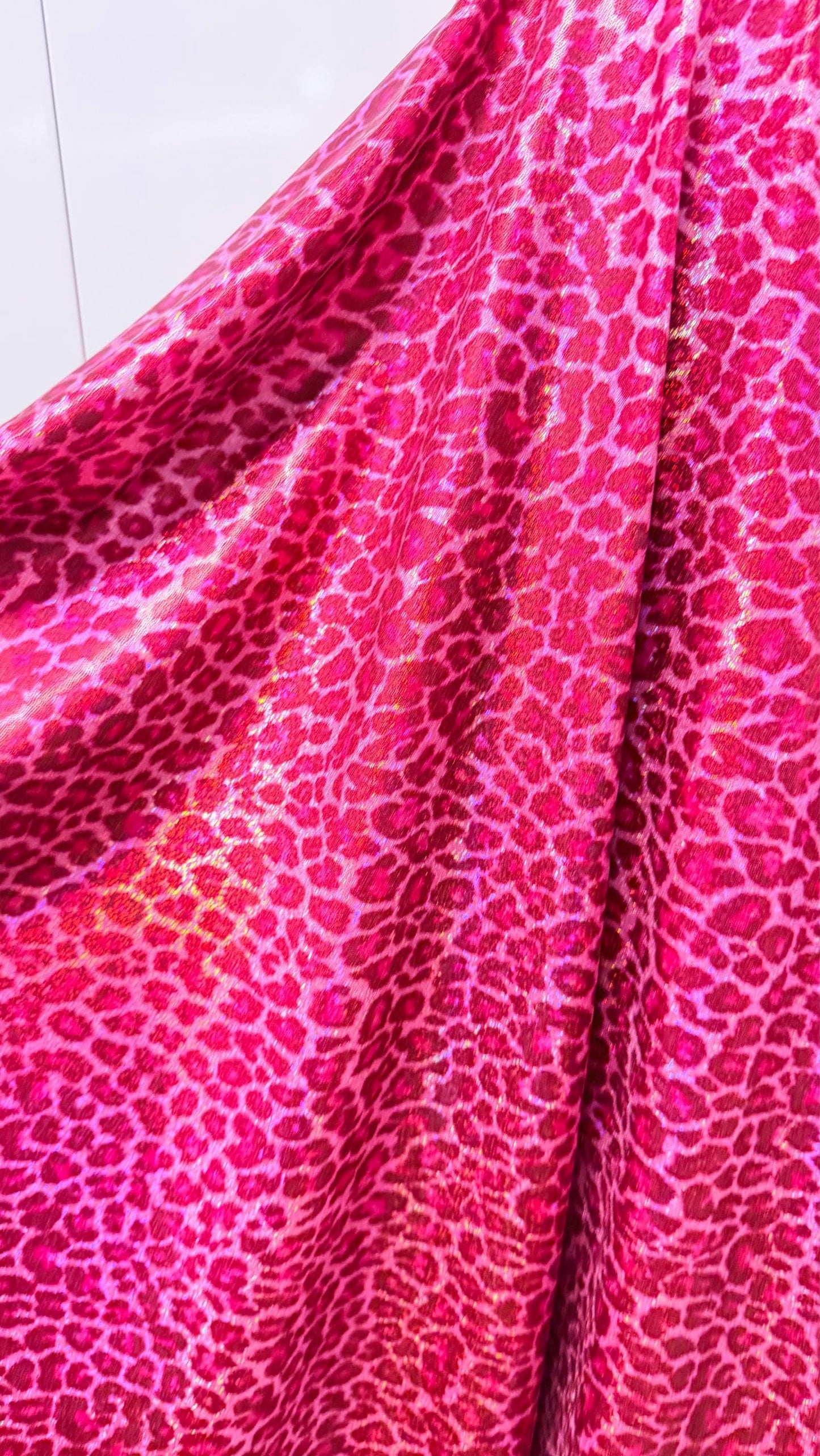 Wild Cheetah design Pink Color on hologram metallic foggy foil nylon spandex 4-way stretch 58/60” Sold by the YD.