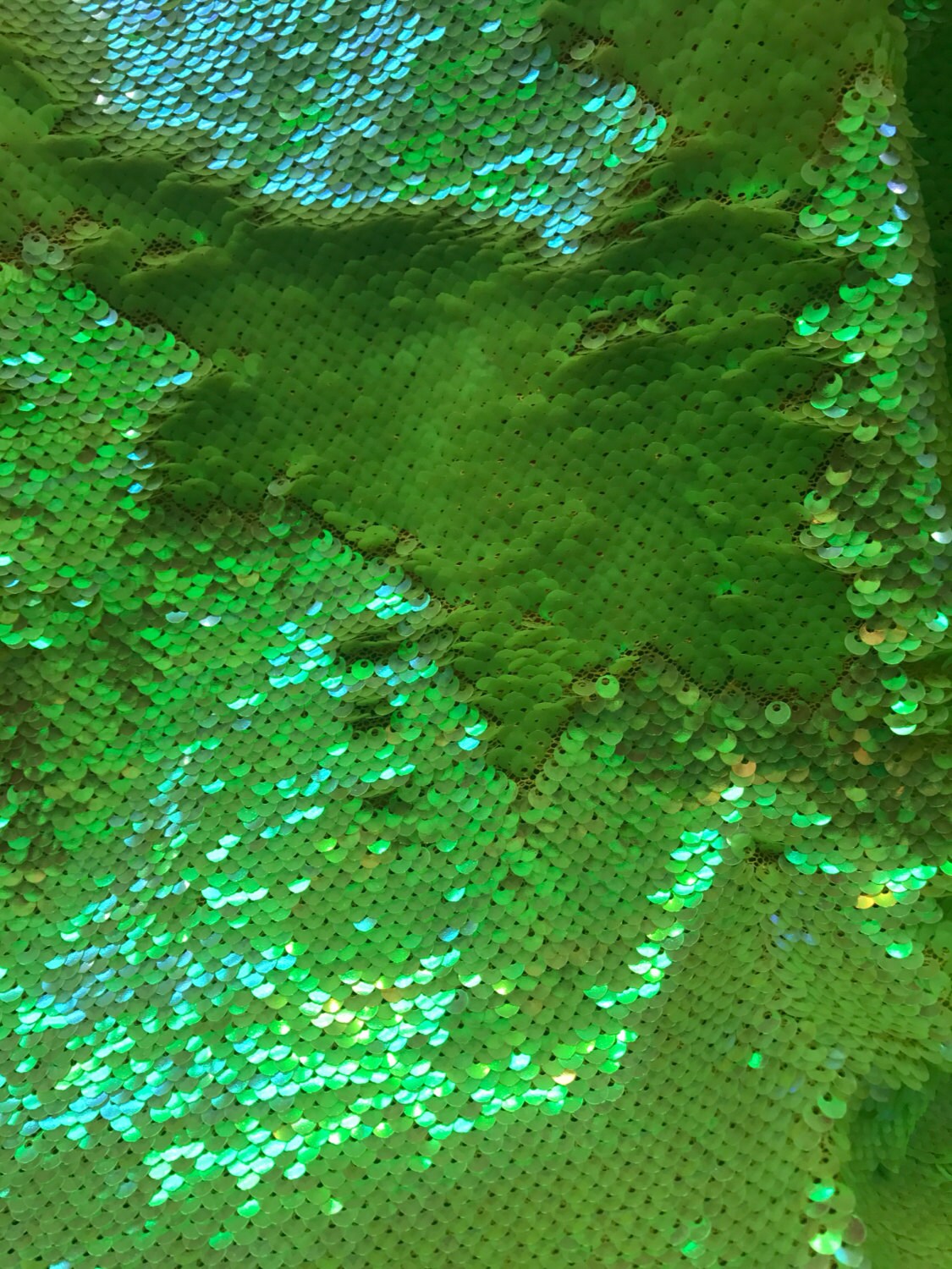 Neon colors Flip Up reversible sequins Sold by the yd strech base. From: Los Angeles, California.