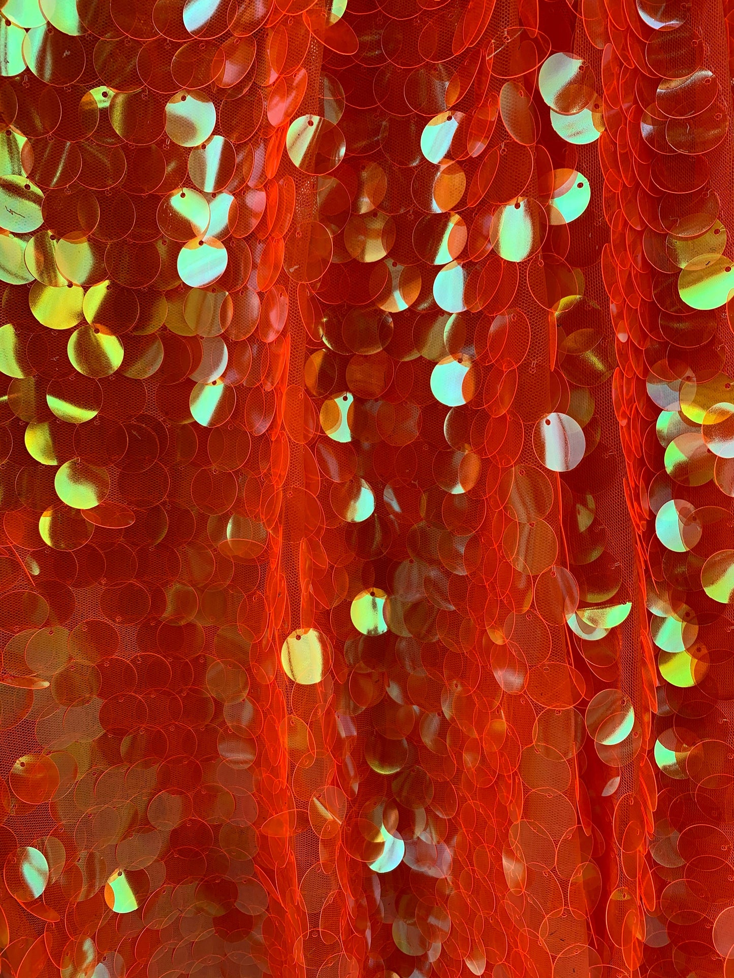 New Neon orange paillette sequins Iridescent orange 20mm size round sequins on stretch mesh 2-way 58/60” Sold by the YD. Ships worldwide.