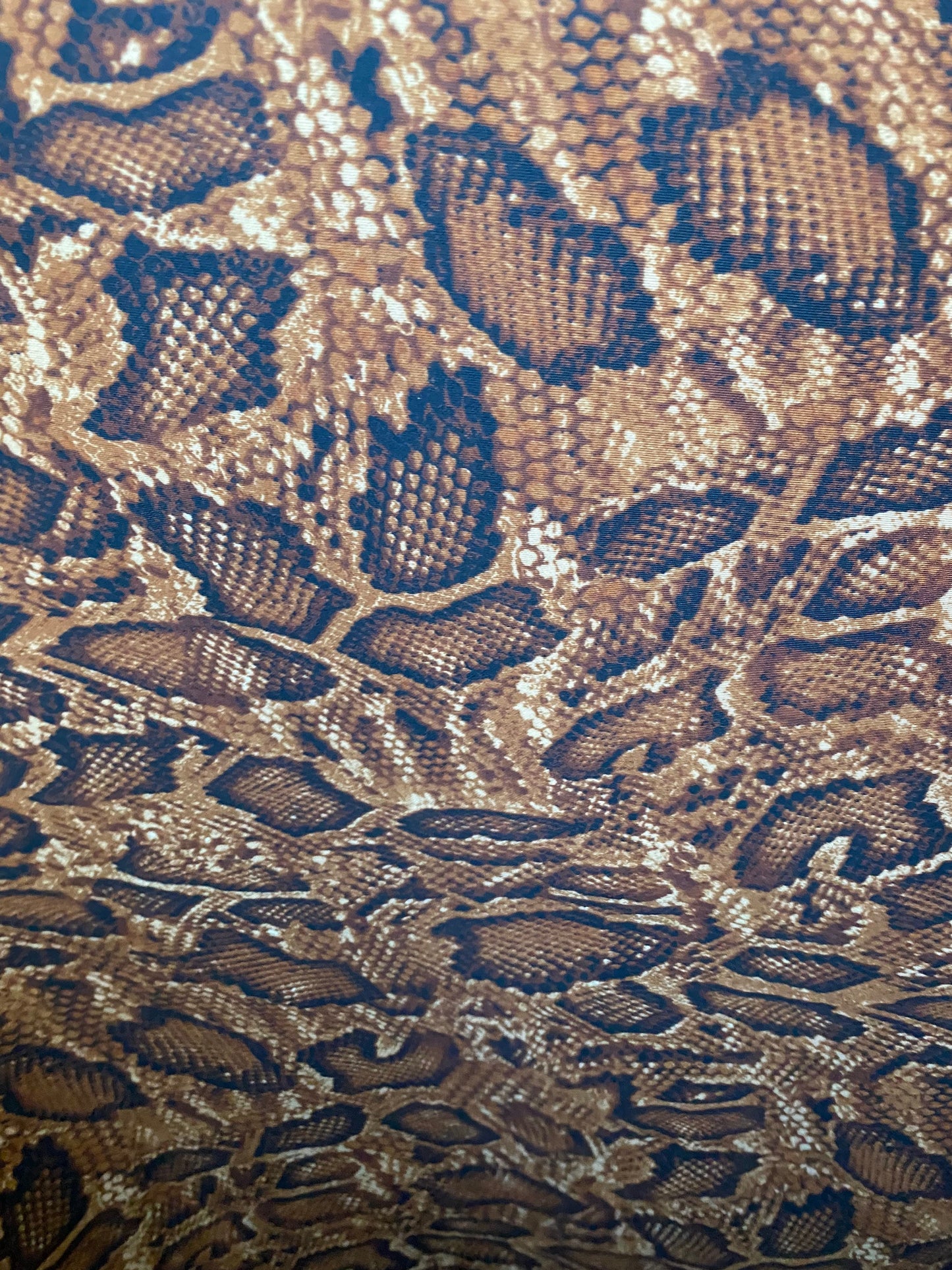 New exotic snake design taupe/sapphire/black print on poly techno 2-way stretch medium weight 58/60” Sold by the YD. Ships worldwide