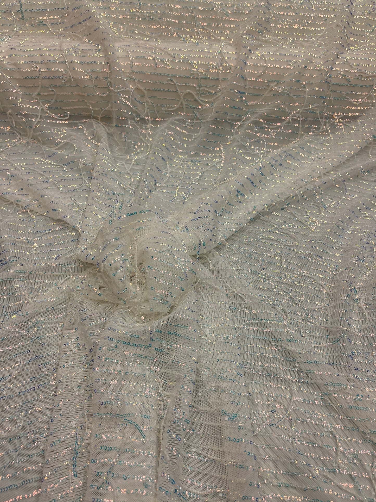 New hanging iridescent sequins embroidered on stretch mesh 2-way 55/57” Sold by the YD. Ships Worldwide from Los Angeles California USA.