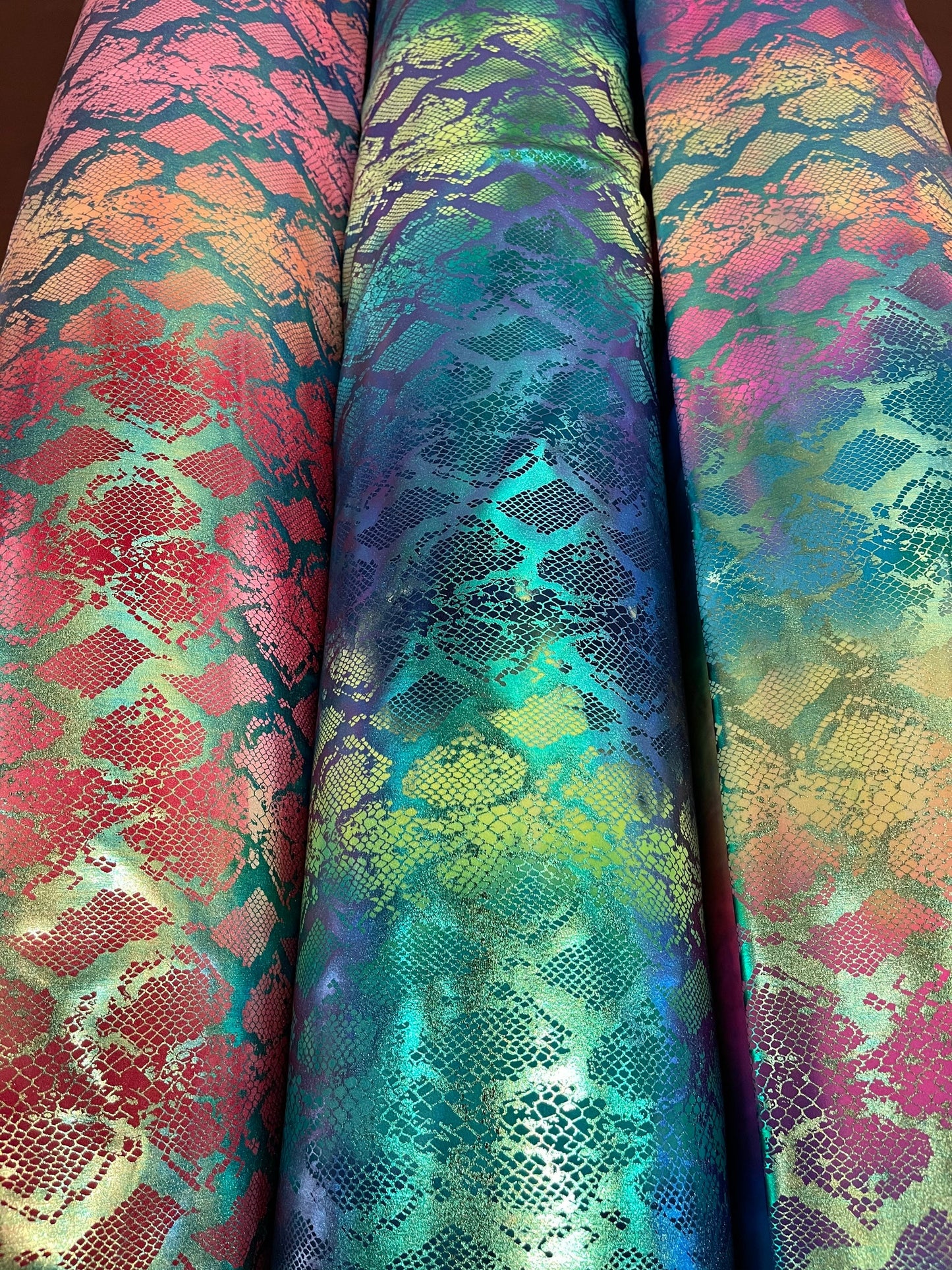 Exotic King snake design tie dye metallic nylon spandex with iridescent foil 4-way stretch 58/60” Sold by the YD. Ships worldwide
