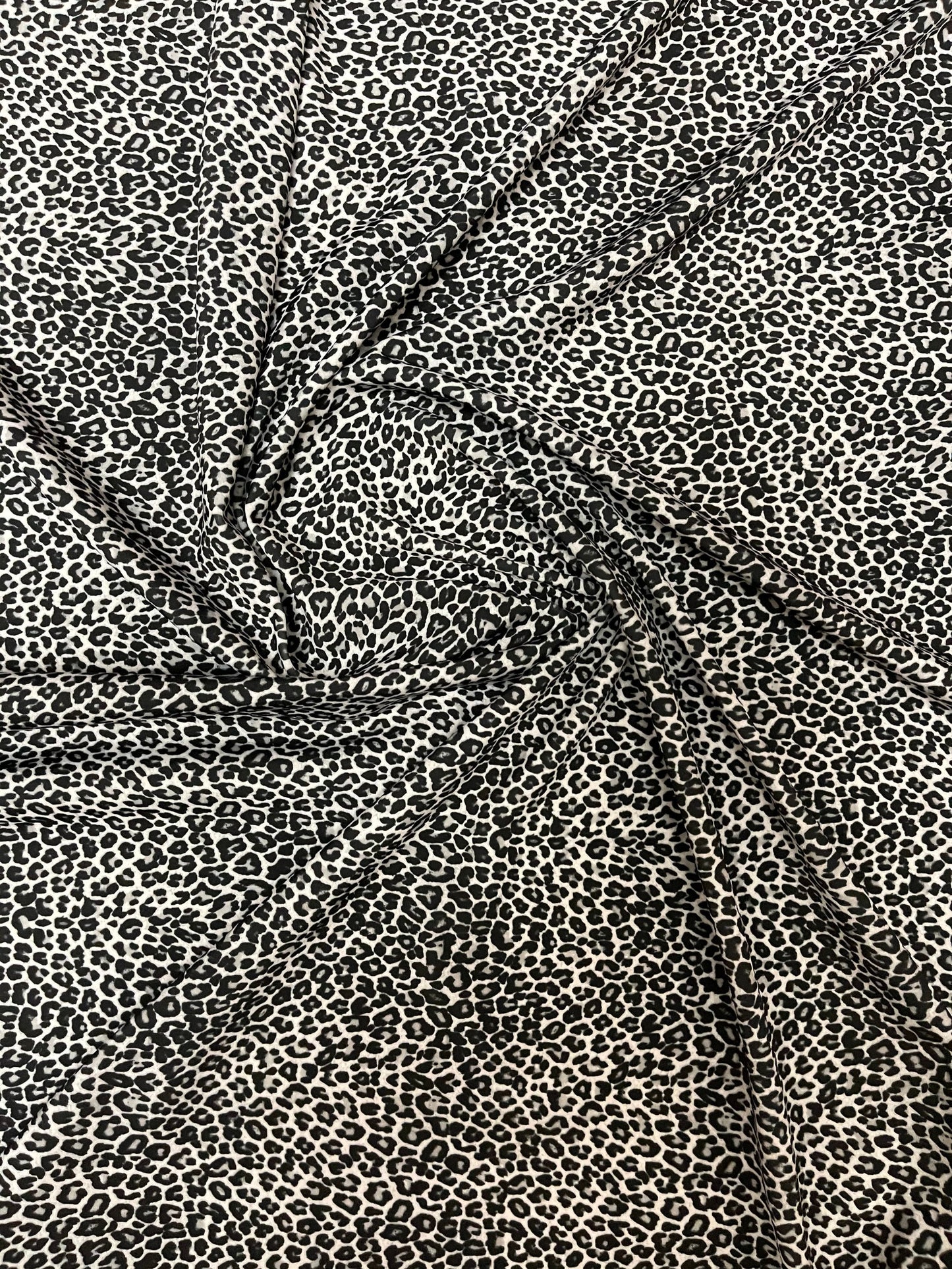Exotic leopard design white/black small size print on great quality of nylon spandex 4-way stretch 58/60” Sold by the YD. Sold by the YD.