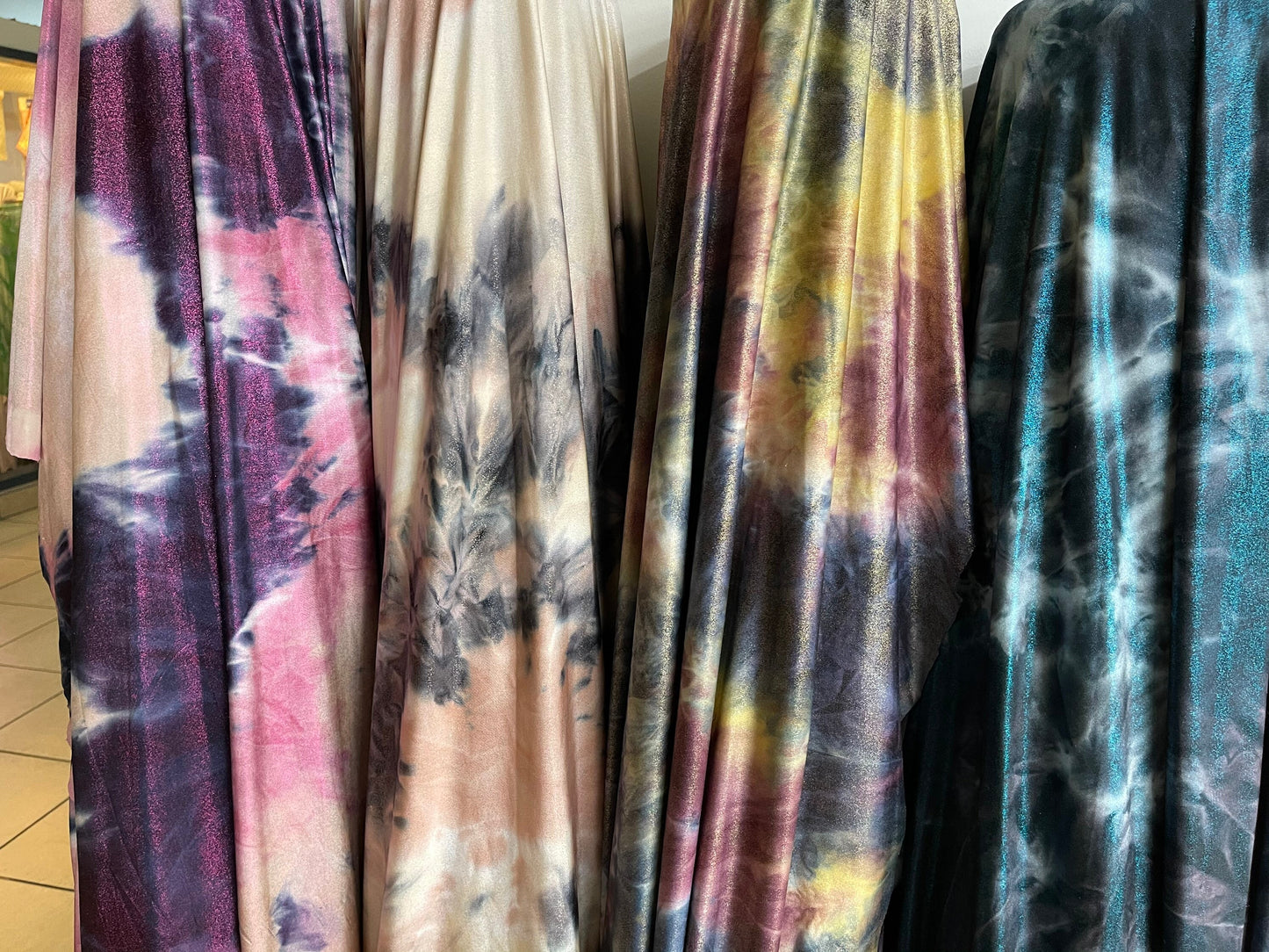 Tie dye design with foggy foil print on poly brushed spandex 2-way stretch 58/60” light weight 58/60” Sold by the YD. Ships Worldwide