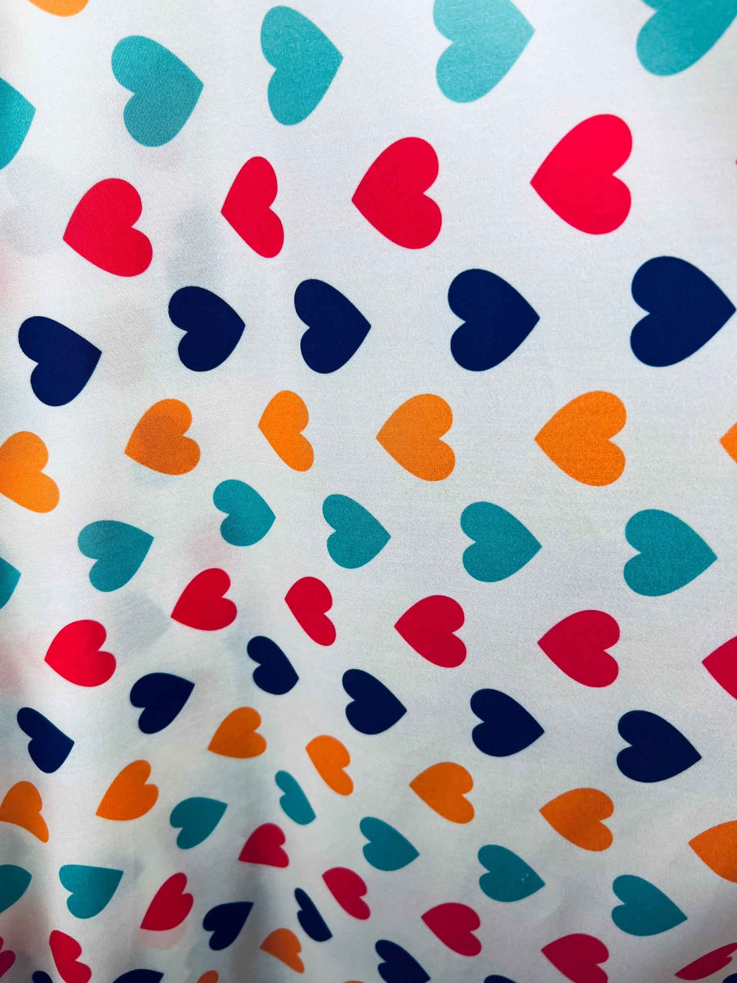 Romantic Hearts design white/multicolor print on great quality of nylon spandex 4-way stretch 58/60” Sold by the YD. Ships Worldwide