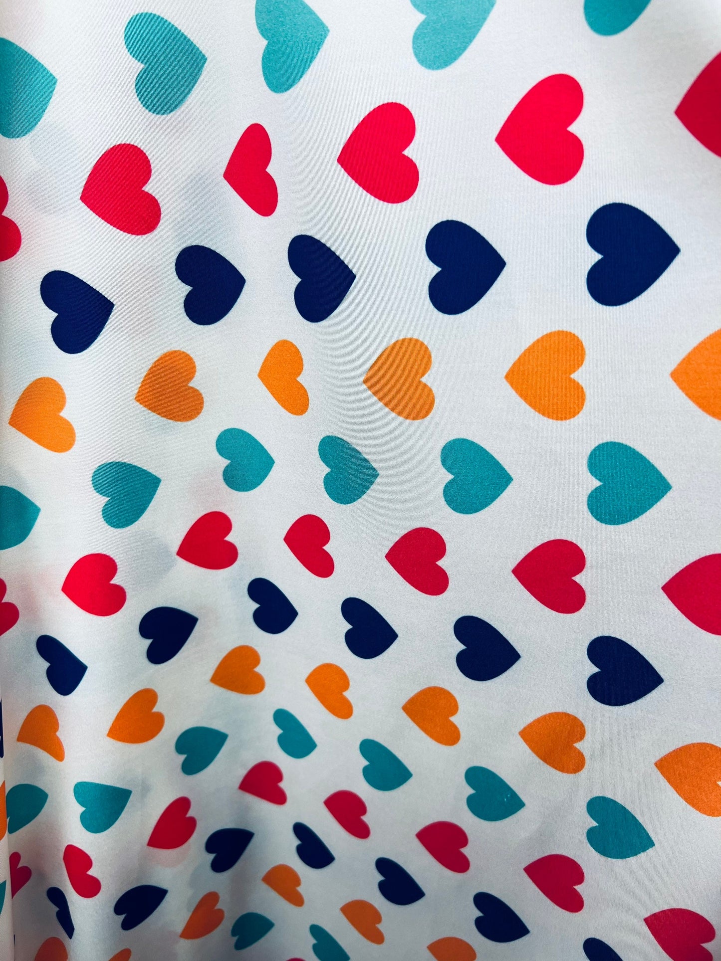 Romantic Hearts design white/multicolor print on great quality of nylon spandex 4-way stretch 58/60” Sold by the YD. Ships Worldwide