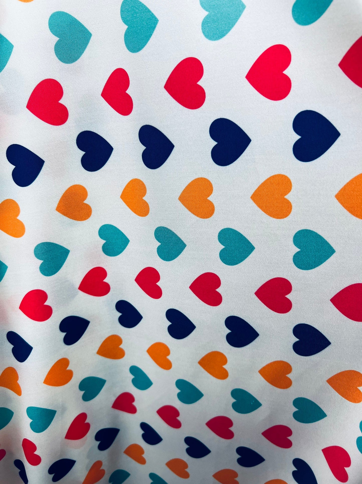 Romantic Hearts design white/multicolor print on great quality of nylon spandex 4-way stretch 58/60” Sold by the YD. Ships Worldwide
