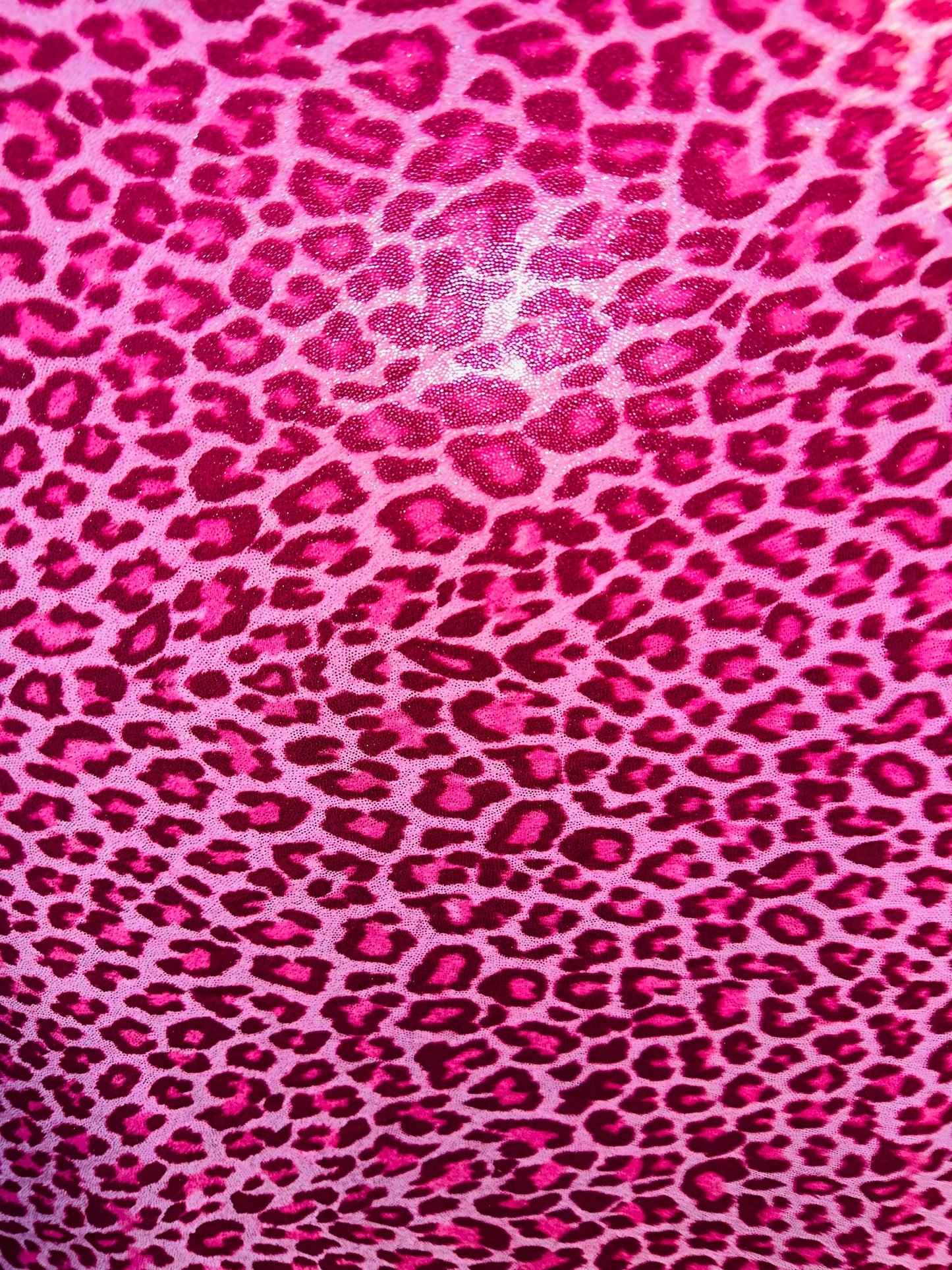 Wild Cheetah design on foggy foil hologram metallic nylon spandex 4-way stretch 58/60” Sold by the YD. Ships worldwide