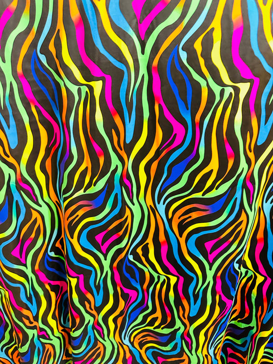 Exotic Zebra design rainbow nylon spandex 4-way stretch it glows under black light.