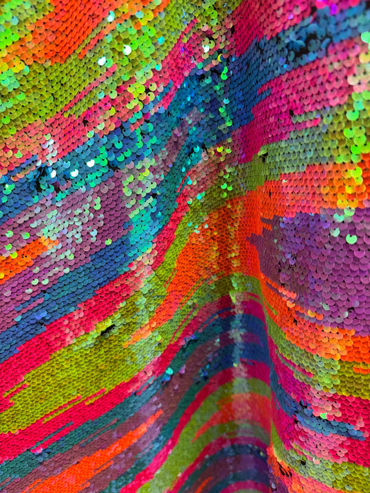 Zig Zag abstract design Rainbow sequins on spandex base 2-way stretch 58/60” Sold by the YD.
