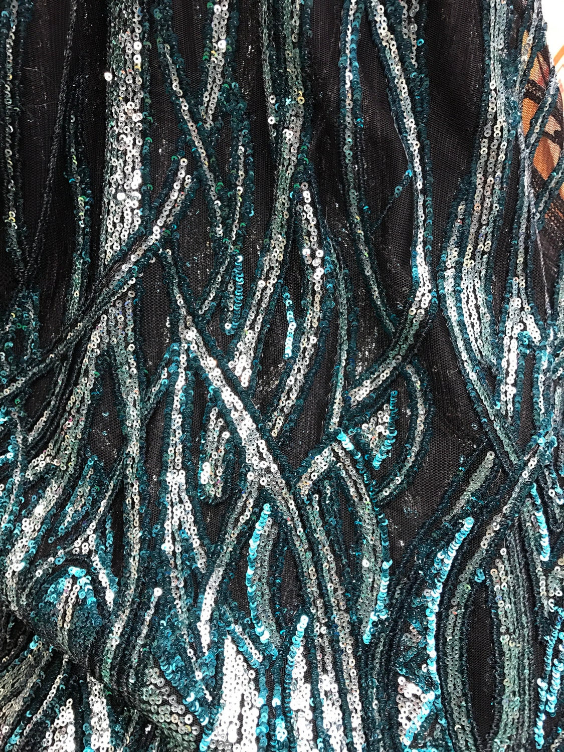 Peacock/silver glitz sequins Leaf Design one side border with mesh base 2way 54/55" Sold by the YD. Ships worldwide from Los Angeles CA, US