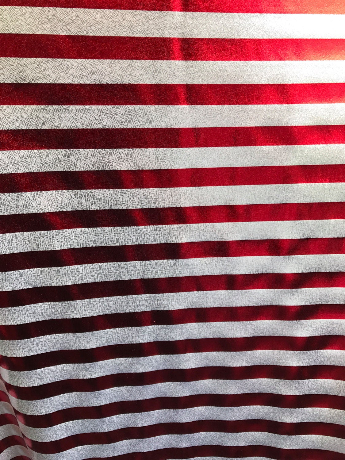 Stripe design nylon spandex 4way metallic foil silver/red 58/60" sold by the Yd. Ships worldwide from Los Angeles California USA.