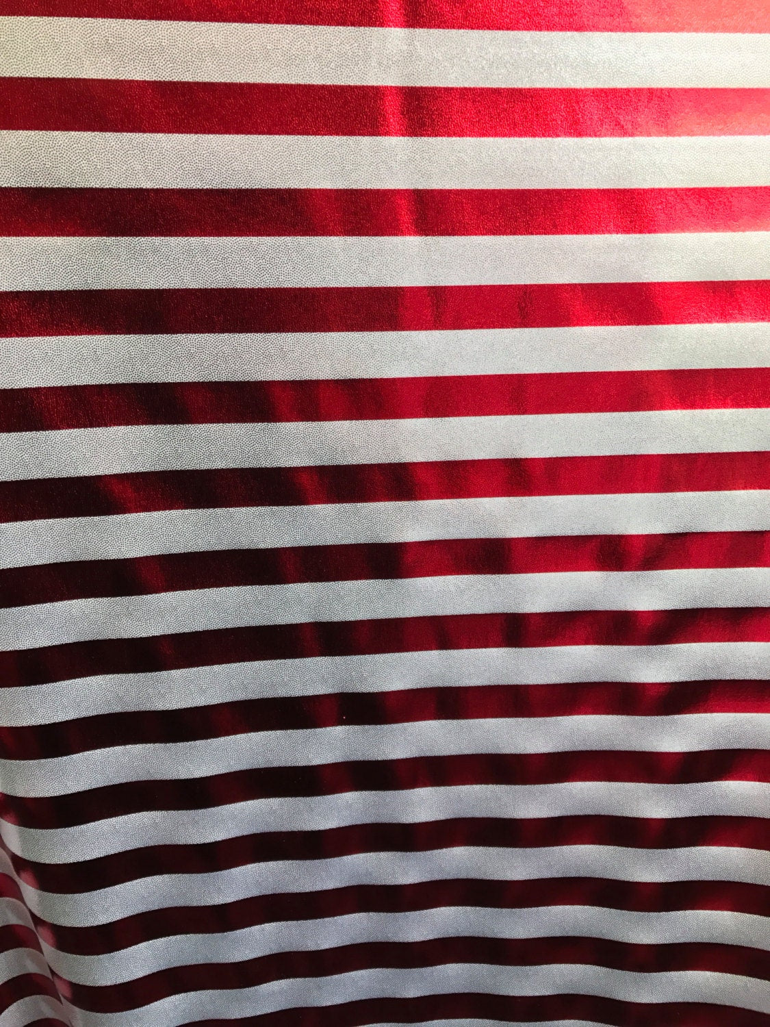 Stripe design nylon spandex 4way metallic foil silver/red 58/60" sold by the Yd. Ships worldwide from Los Angeles California USA.