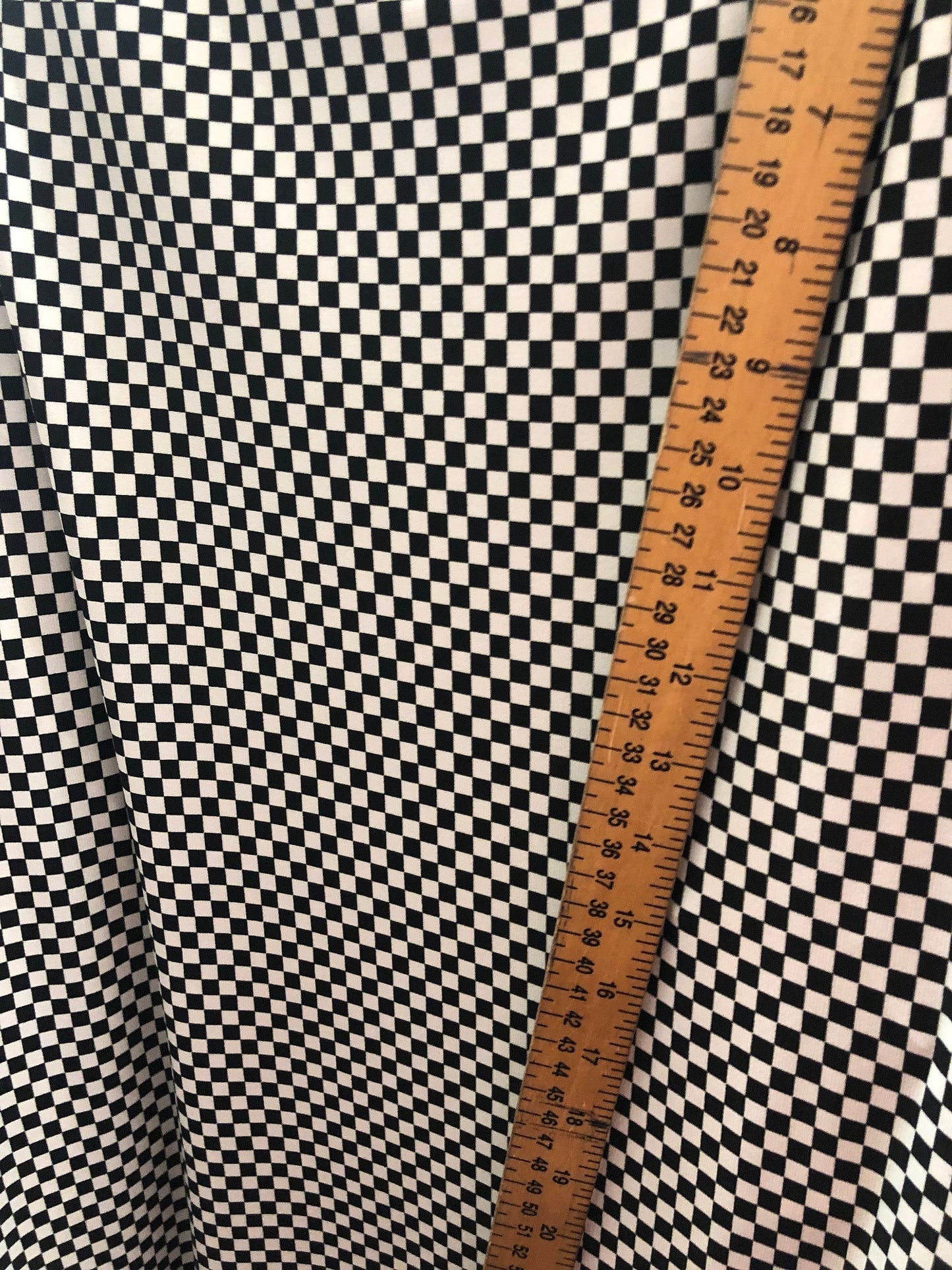 Small checkers design on poly spandex medium weight 58/60" Sold by the YD. Ships Worldwide from Los Angeles California USA.