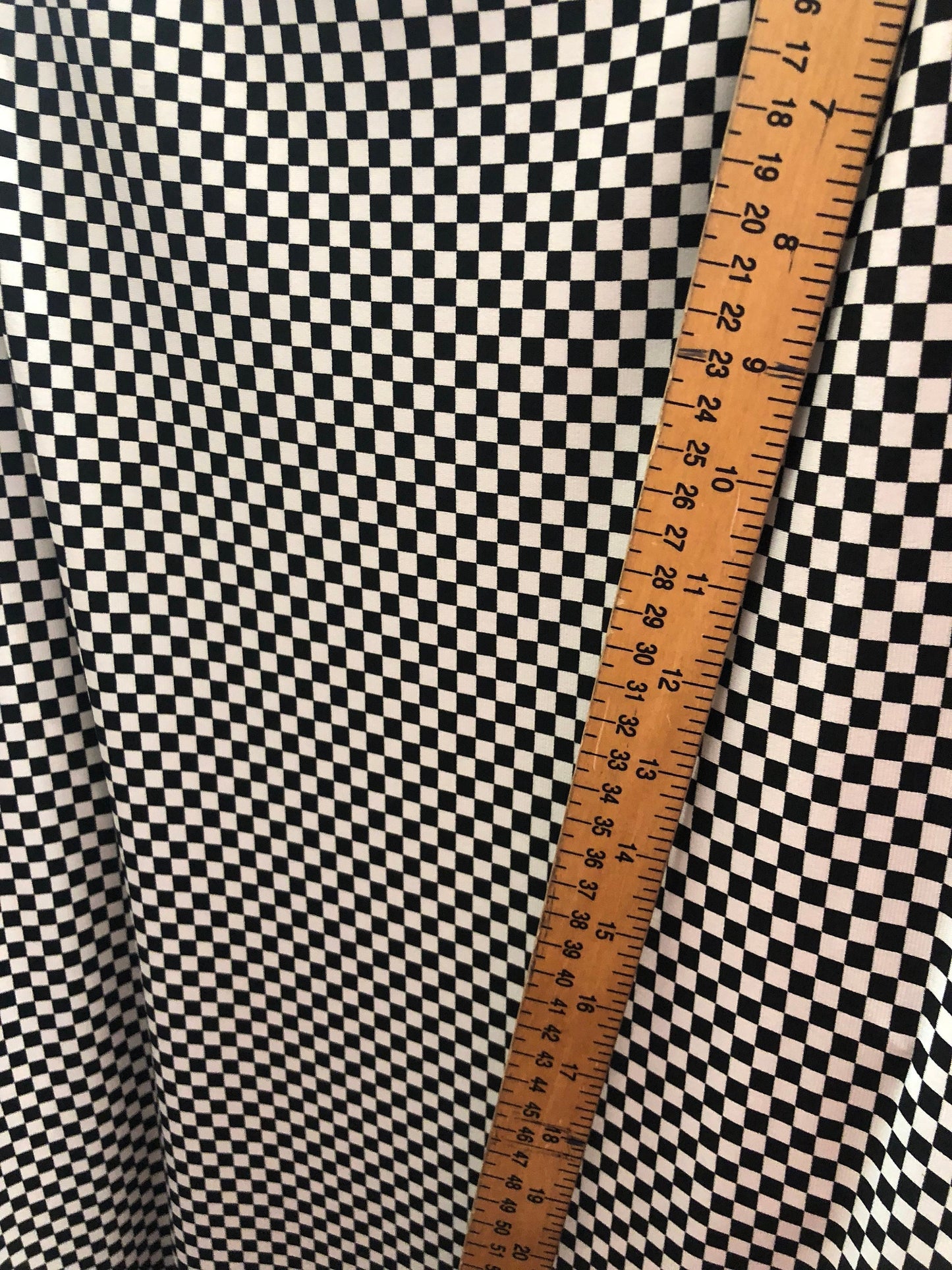 Small checkers design on poly spandex medium weight 58/60" Sold by the YD. Ships Worldwide from Los Angeles California USA.
