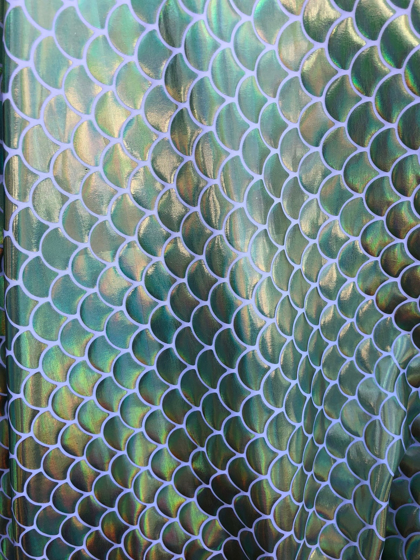 New mermaid fish scale iridescent olive green foil on nylon spandex 4way Stretch 58/60" Sold by the YD. Ships worldwide from Los Angeles CA.