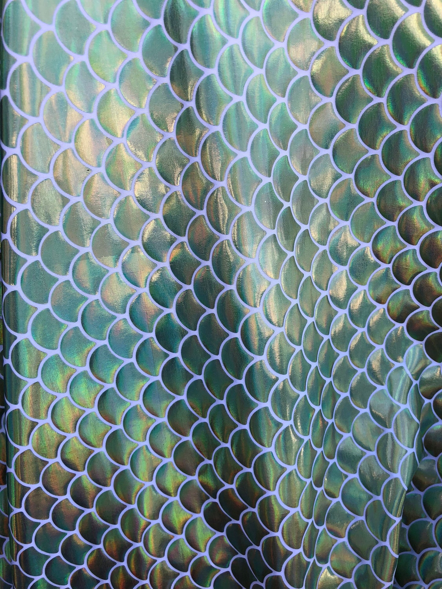 New mermaid fish scale iridescent olive green foil on nylon spandex 4way Stretch 58/60" Sold by the YD. Ships worldwide from Los Angeles CA.