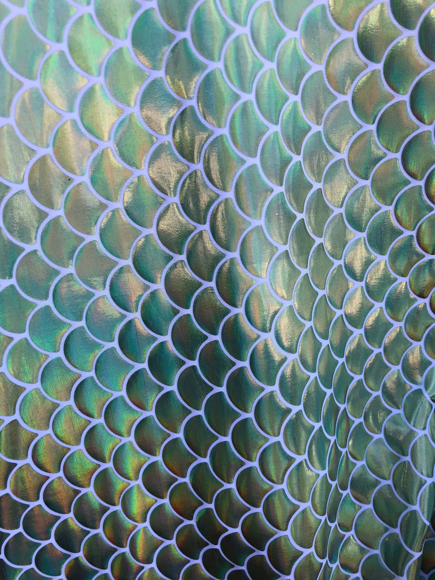 New mermaid fish scale iridescent olive green foil on nylon spandex 4way Stretch 58/60" Sold by the YD. Ships worldwide from Los Angeles CA.