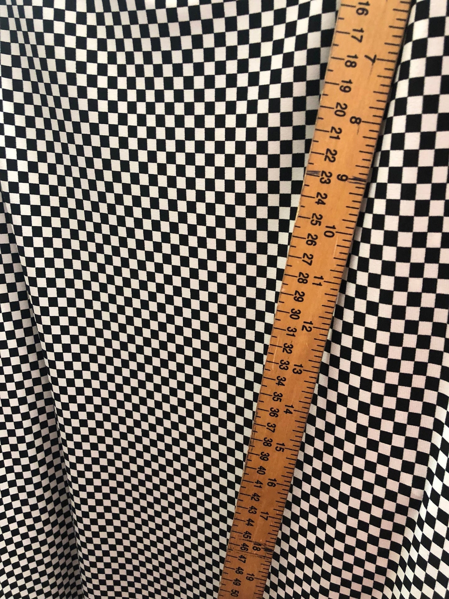 Small checkers design on poly spandex medium weight 58/60" Sold by the YD. Ships Worldwide from Los Angeles California USA.