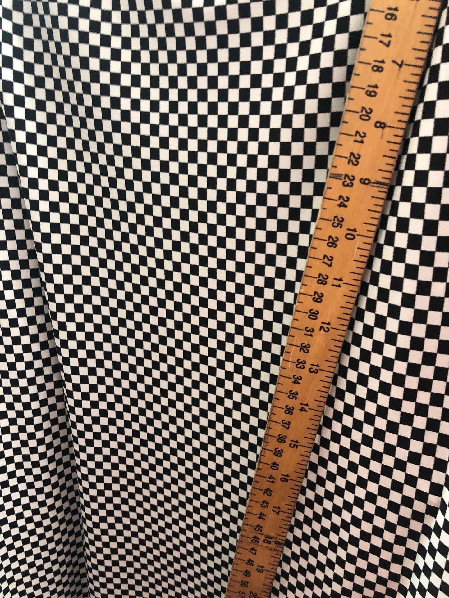 Small checkers design on poly spandex medium weight 58/60" Sold by the YD. Ships Worldwide from Los Angeles California USA.