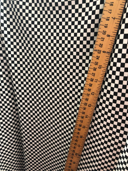 Small checkers design on poly spandex medium weight 58/60" Sold by the YD. Ships Worldwide from Los Angeles California USA.