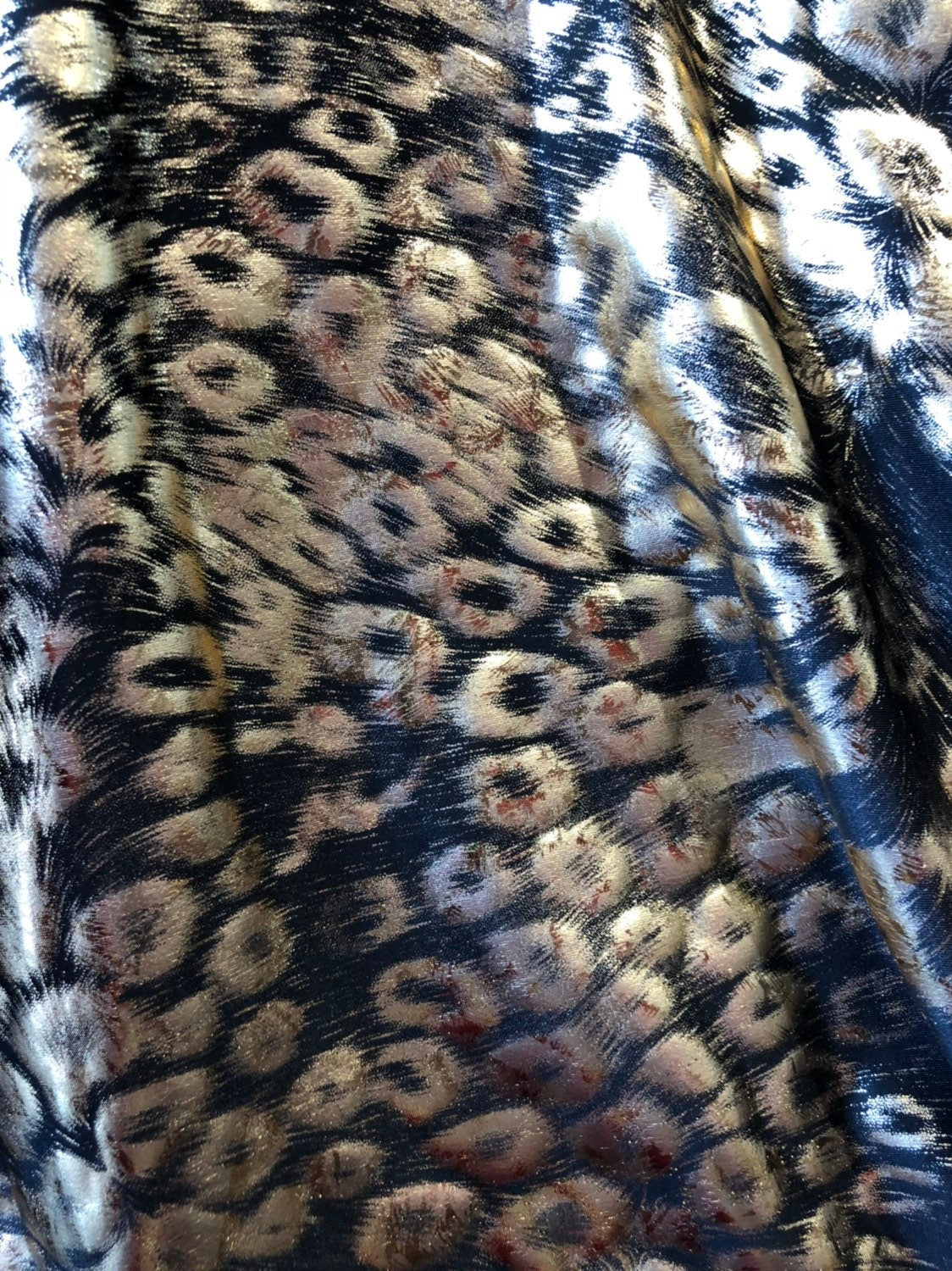 Animal print design black/gold metallic spandex 4way stretch 58/60" Sold by the YD. Ships worldwide from Los Angeles California USA.