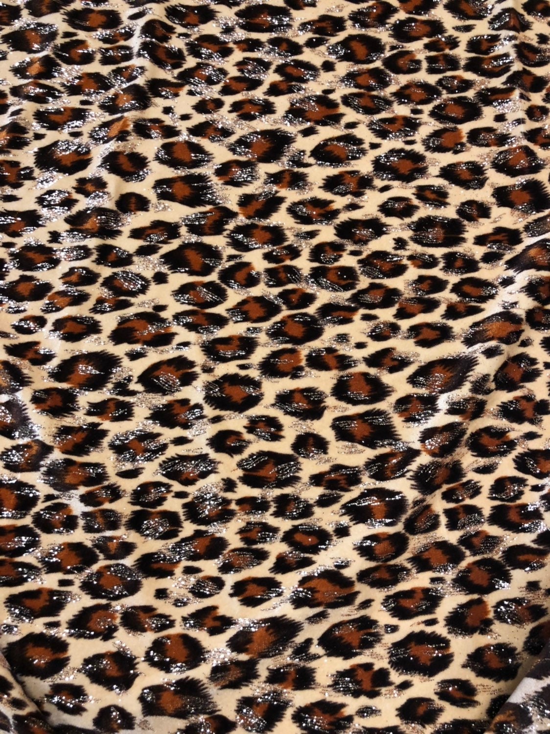 Leopard design with gold glitter print on velvet 420gsm 4way stretch 58/60" Sold by the YD. Ships worldwide from Los Angeles California USA.